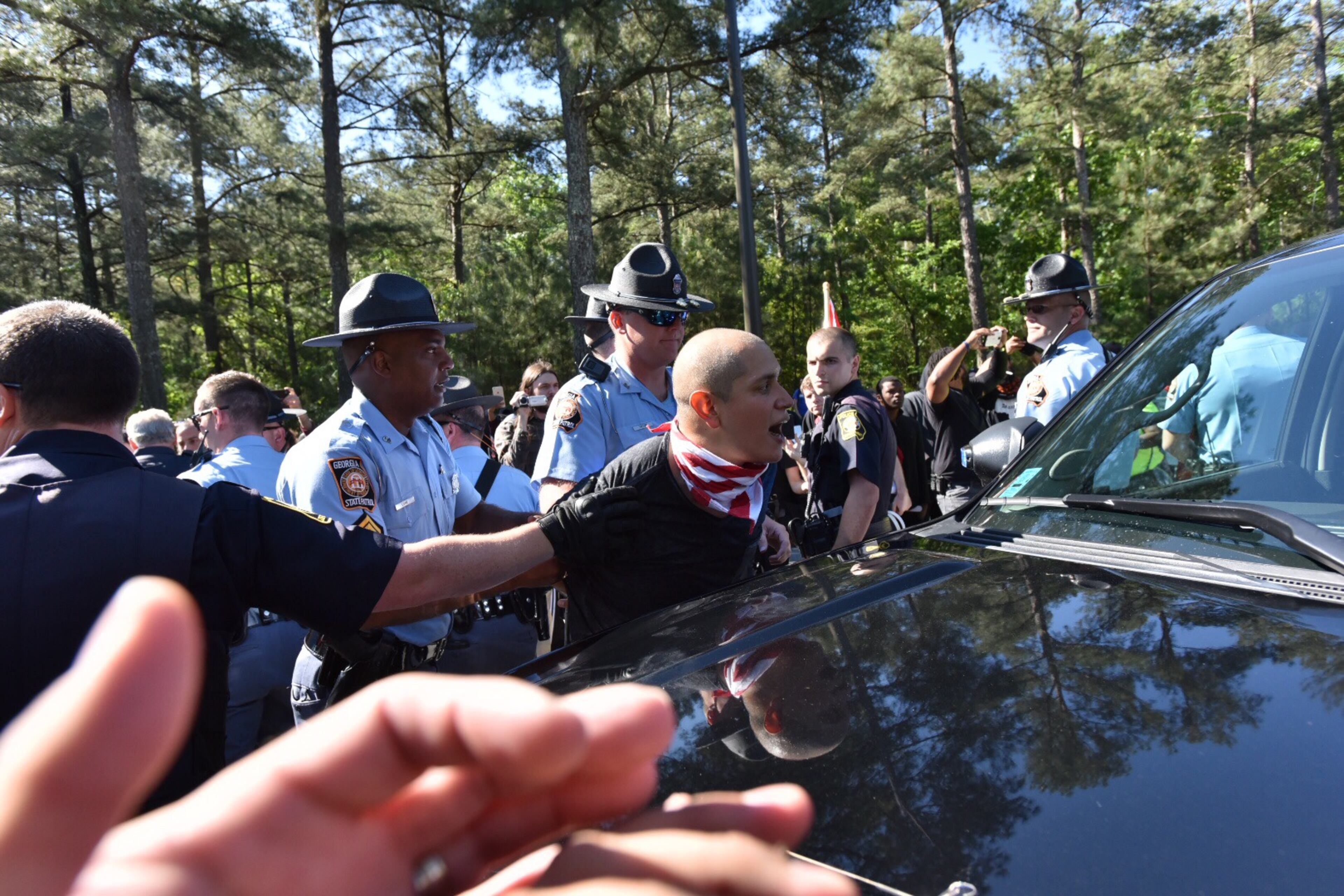 Protesters clash with police near a “white power” rally in Stone Mountain on Saturday, April 23, 2016. The protesters said they are opposing the message of hate at the supremacist rally also taking place at the park.