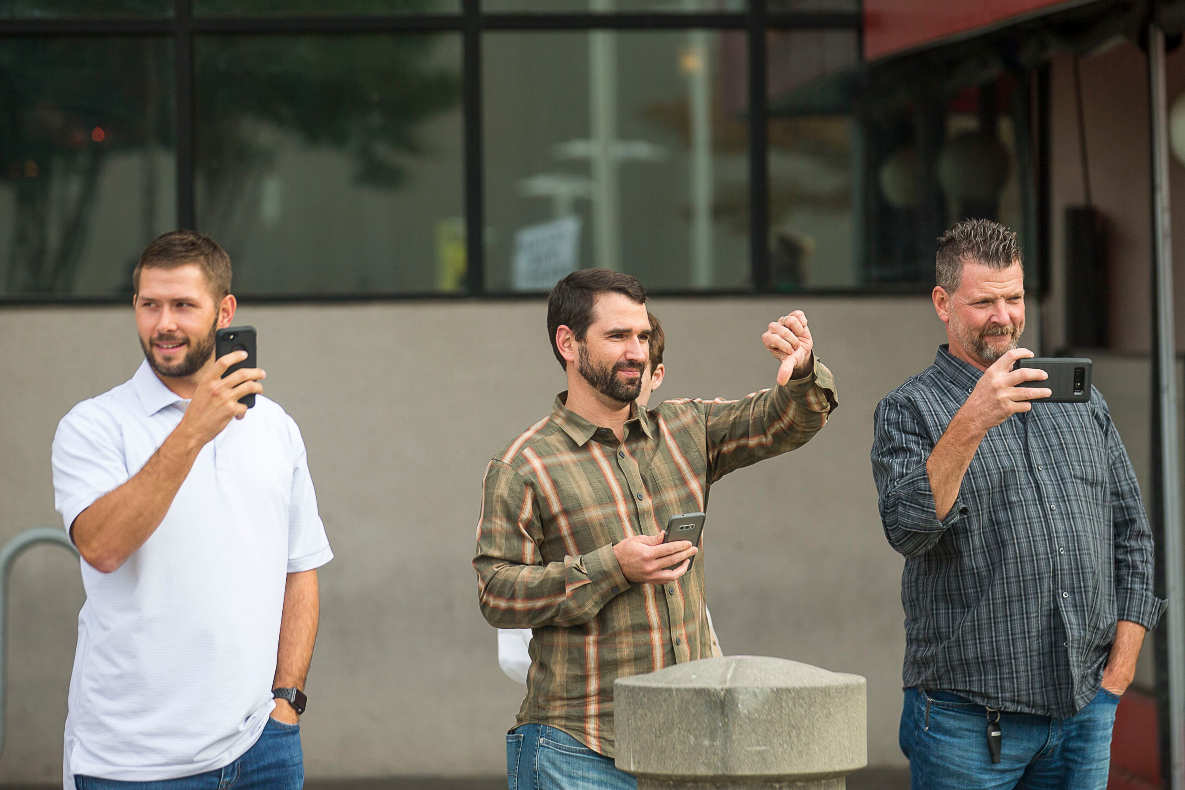 11/08/2019 -- Atlanta, Georgia -- Supporters of President Donald Trump show their disapproval of a crowd of anti-Trump protestors as they rally outside of the Georgia World Congress Center in downtown Atlanta, Friday, November 8, 2019. These men did not want to give their names. (Alyssa Pointer/Atlanta Journal Constitution)