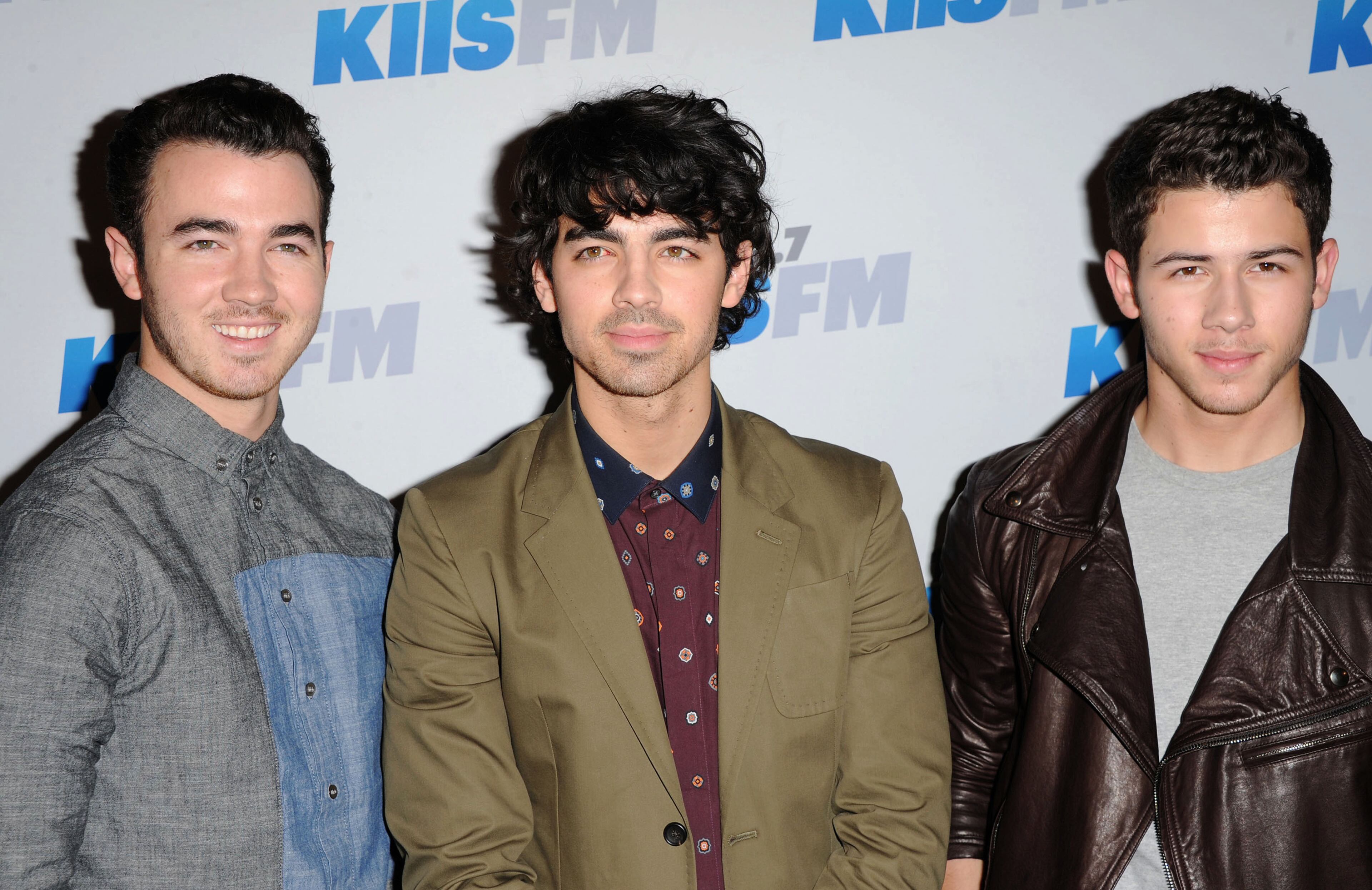 The Jonas Brothers, from left, Kevin, Joe and Nick, arrive at KIIS FM's Jingle Ball at Nokia Theatre LA Live on Saturday, Dec. 1, 2012, in Los Angeles. (Photo by Katy Winn/Invision/AP)