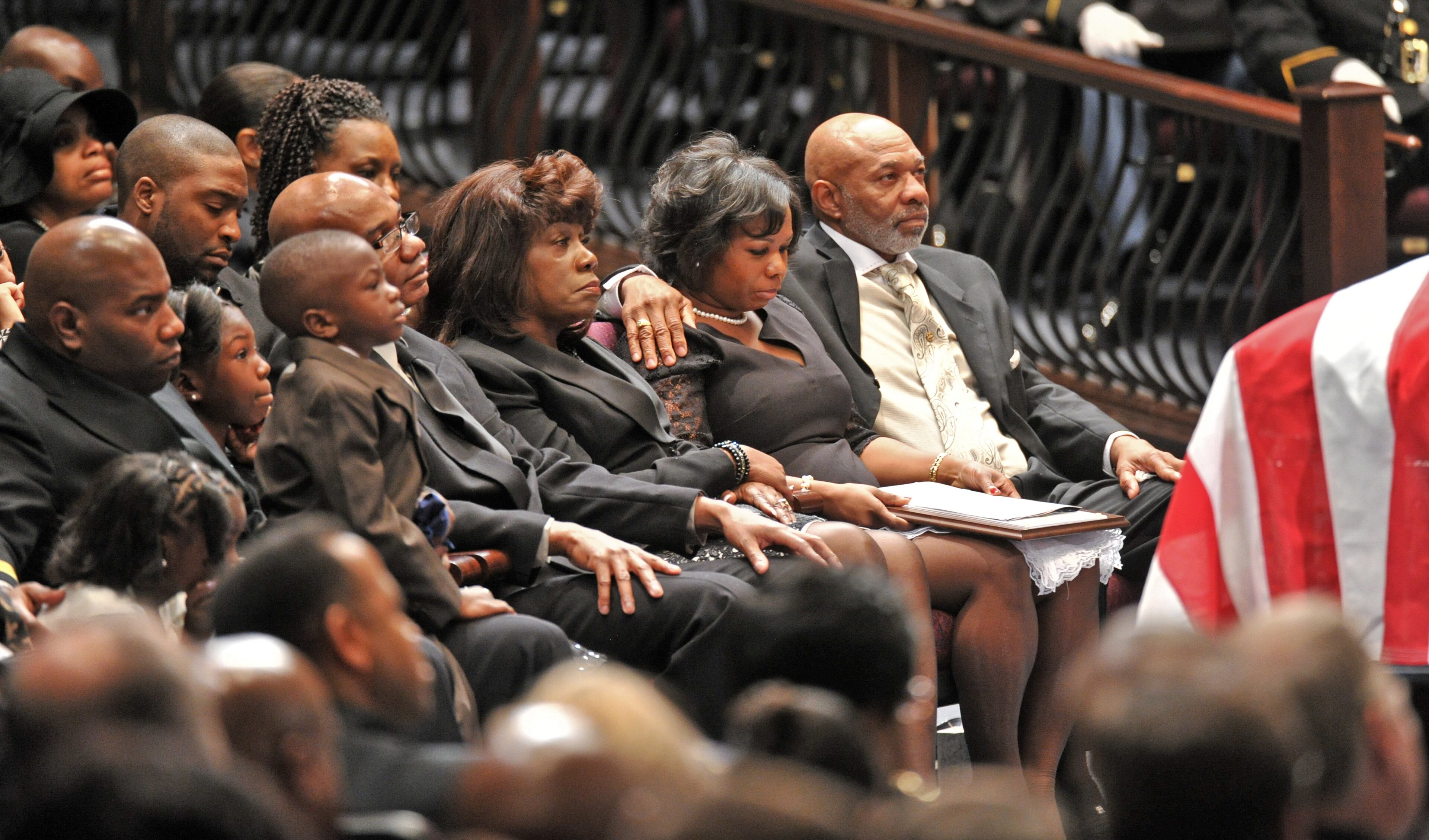 From front row left corner, Elizabeth Smiley (daugher), Joshua Sanders (best friend), Victoria Smiley (daughter), William Smiley (son), Phillip Small (uncle), Carol Smiley (mother), Terra Smiley (wife), and Thomas Jones (father-in-law) sit before the casket during APD Officer Shawn Smiley's funeral at First Baptist Church of Atlanta on Saturday, November 10, 2012. APD Officer Shawn Smiley was in the passenger seat last weekend when an APD helicopter searching for a missing 9-year-old boy crashed in Atlanta. HYOSUB SHIN / HSHIN@AJC.COM