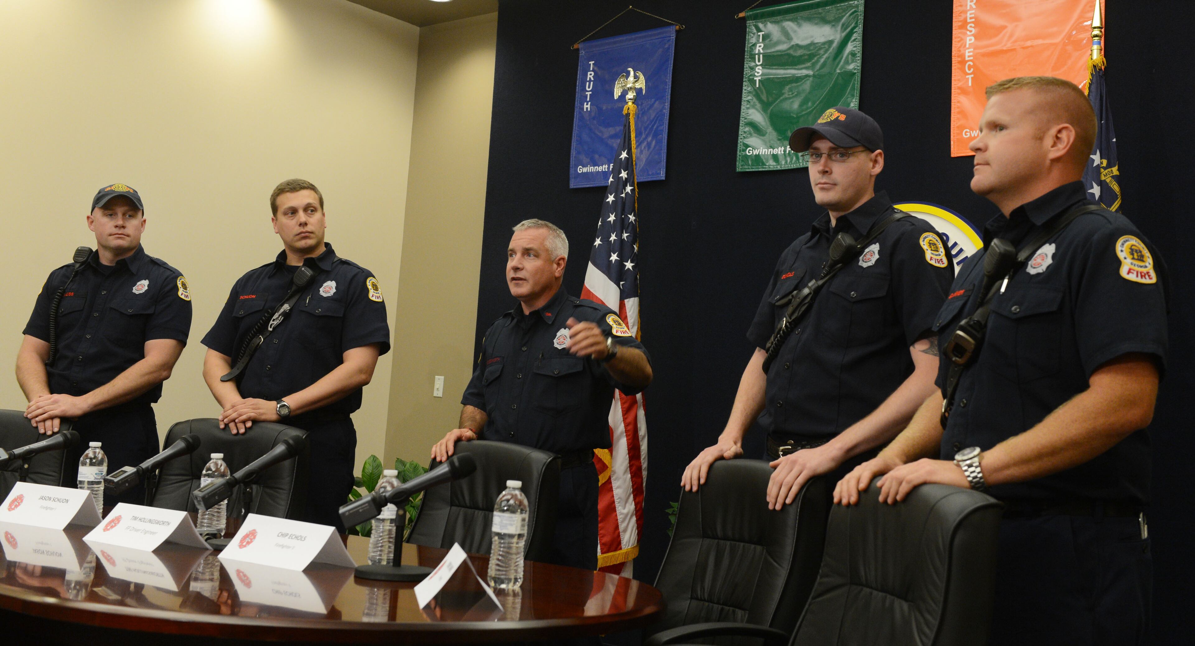 Firefighter Tim Hollingsworth (center) introduces the crew that was held hostage by a gunman. From left: Jody Moss, Jason Schuon, Chip Echols, and Sidney Garner. The Gwinnett County firefighters talked about their experiences of being held hostage by a gunman during a press conference at Gwinnett County Department of Fire and Emergency Services headquarters Tuesday, April 16, 2013.