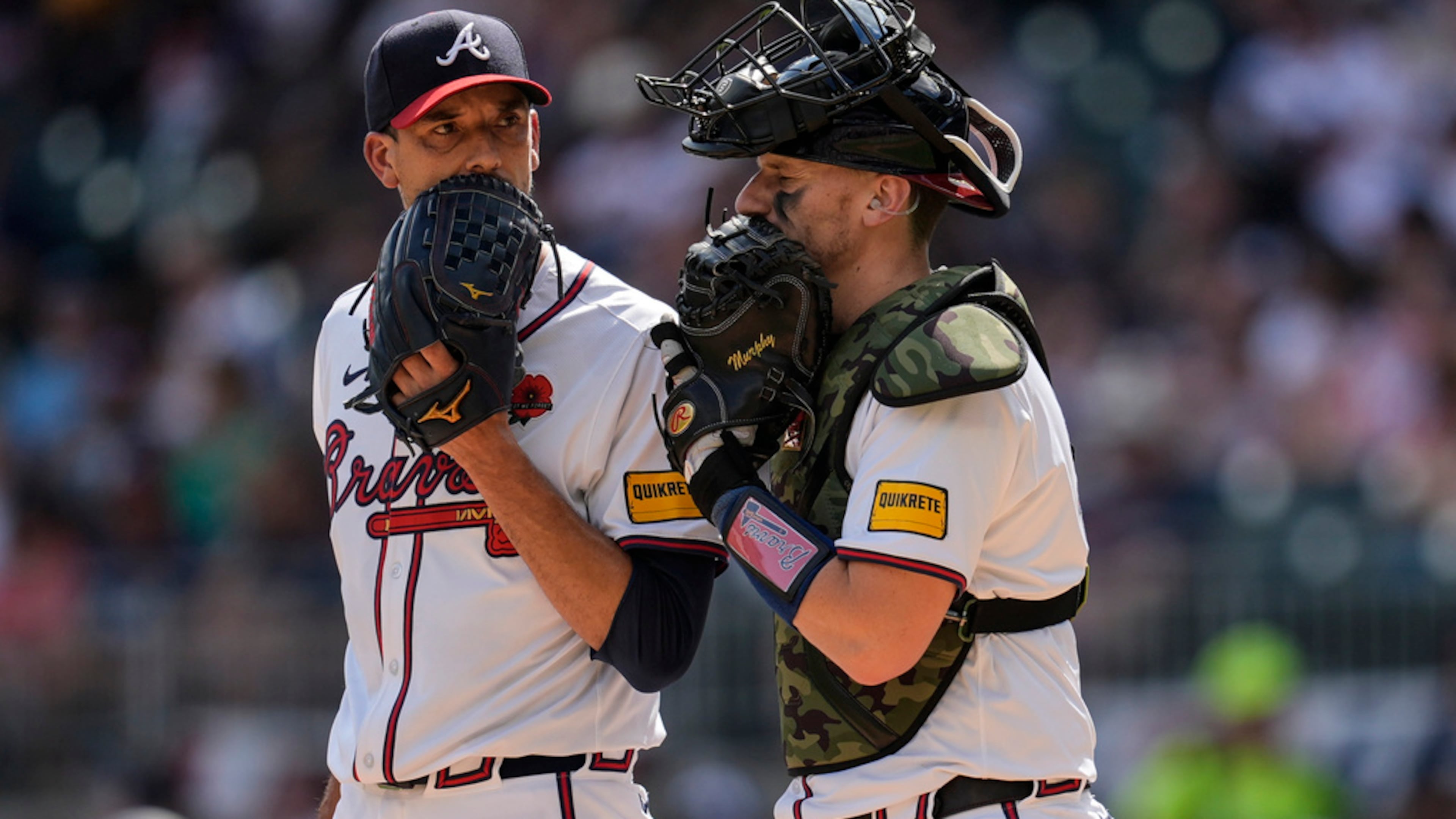 Atlanta Braves pitcher Charlie Morton, left, and catcher Sean Murphy speak on the mound in the first inning of a baseball game against the Washington Nationals, Monday, May 27, 2024, in Atlanta. (AP Photo/Mike Stewart)