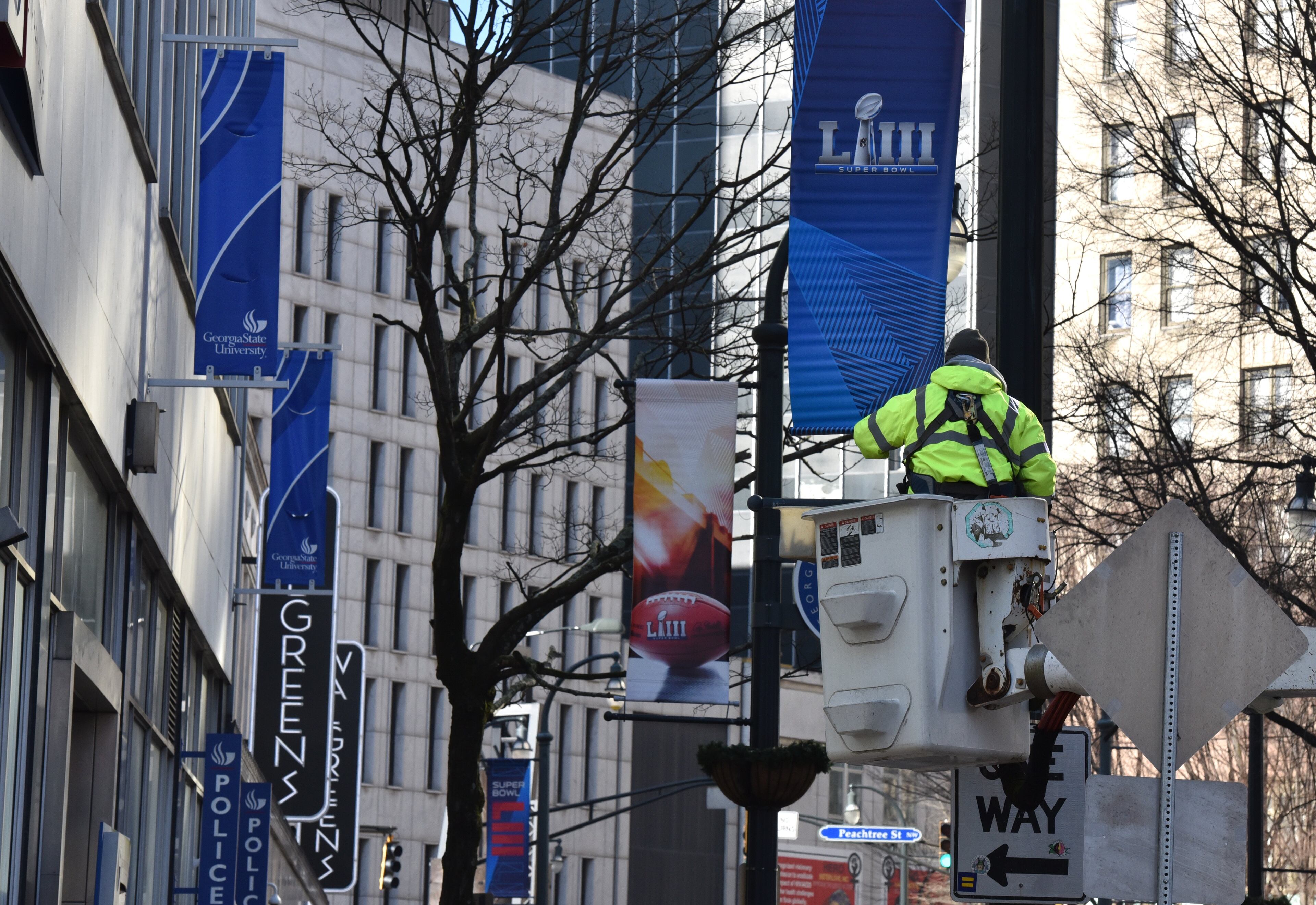 January 16, 2019 Atlanta - Keith Bentley, contractor, installs Super Bowl LIII banners near Woodruff Park in downtown Atlanta on Wednesday, January 16, 2019. Atlanta faces a test on Super Bowl Sunday and the question with less than a month to go before the big game is this: Is the city ready? The city budgeted some $10 million last year for police, fire and other items to assist with the big game. HYOSUB SHIN / HSHIN@AJC.COM