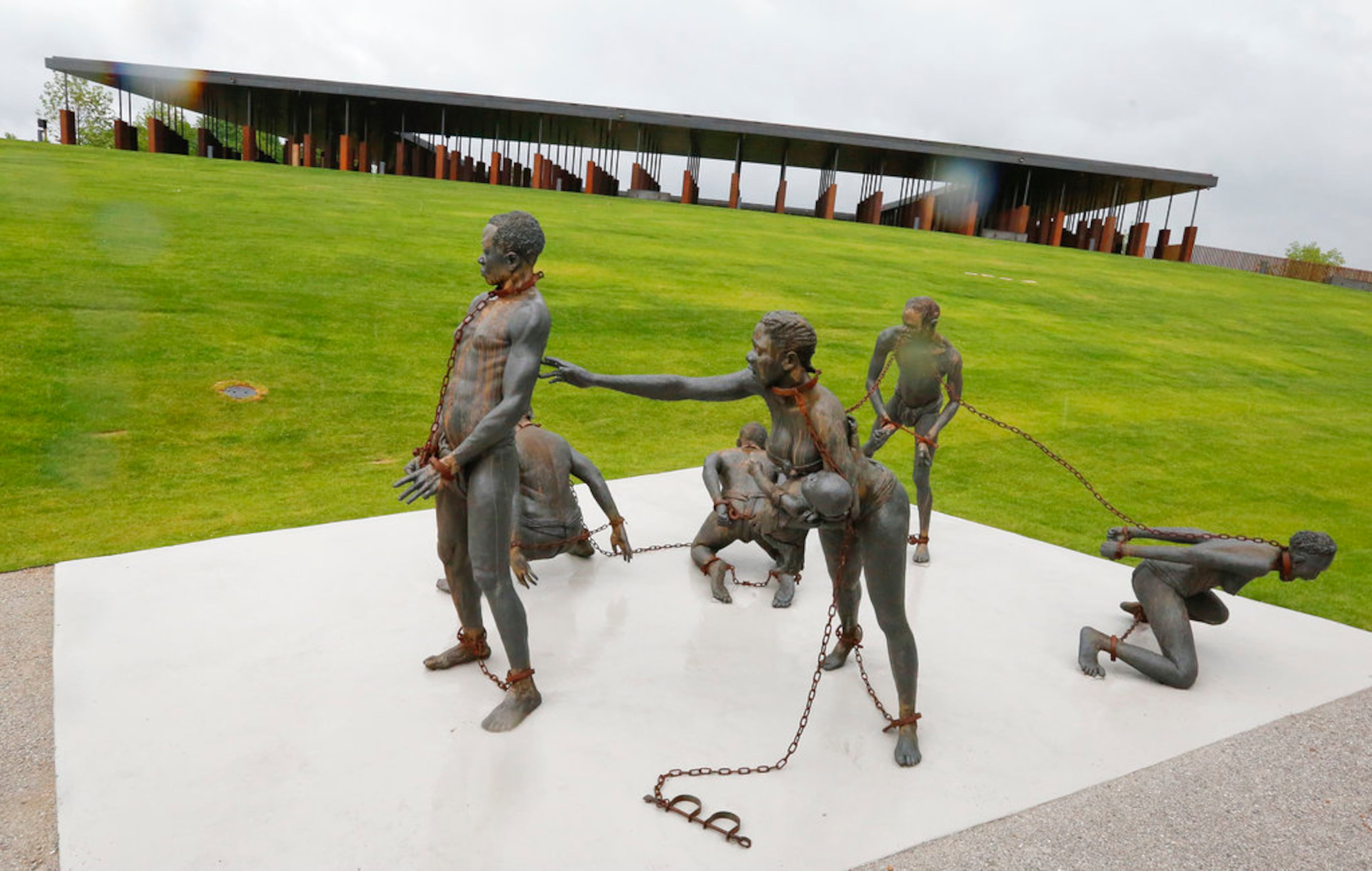 A statue of chained people is on display at the National Memorial for Peace and Justice, the new memorial is opening to honor thousands of people killed in racist lynchings on Sunday, April 22, 2018, in Montgomery, Ala. The Memorial and Justice and the Legacy Museum will open on Thursday. (AP Photo/Brynn Anderson)