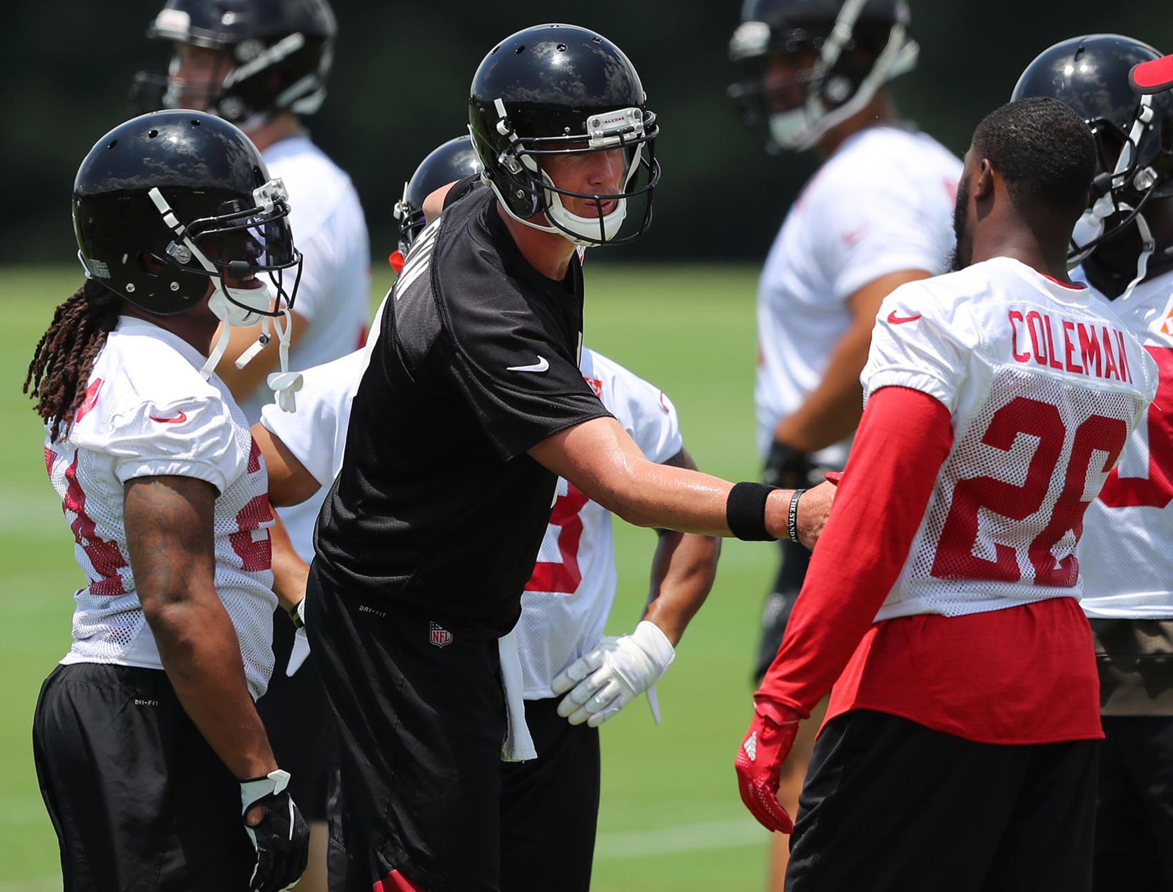 June 13, 2017, Flowery Branch: Falcons quarterback Matt Ryan greets running backs Devonta Freeman (left) and Tevin Coleman during the first day of mini-camp on Tuesday, June 13, 2017, in Flowery Branch. Curtis Compton/ccompton@ajc.com