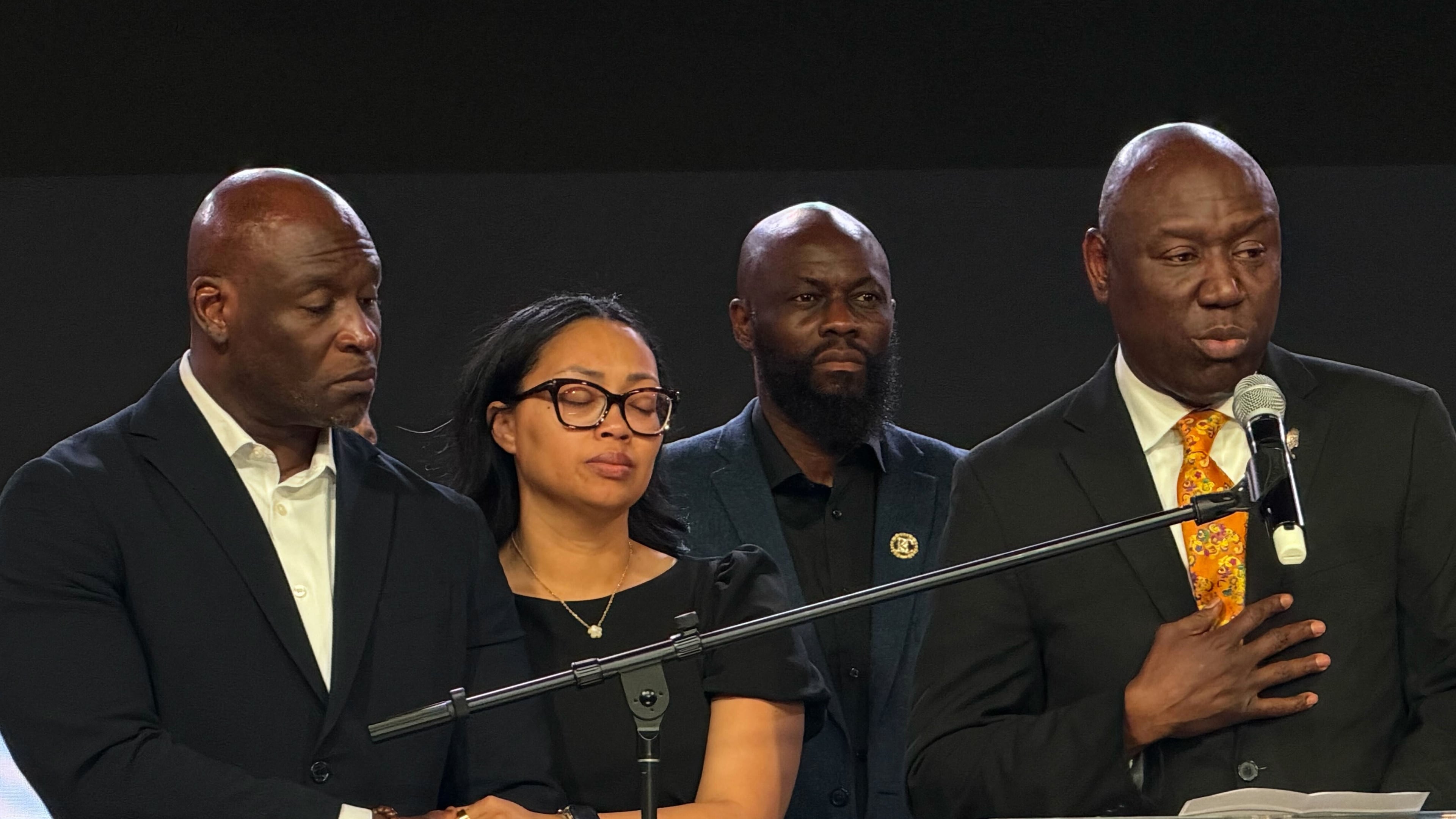 In this photo taken with a smartphone, Ben Crump, right, an attorney for the family of Nolan Wells, speaks at a news conference in Stonecrest, Ga., Thursday, Sept. 22, 2026, accompanied by Wells' parents, Elmore and Christine Wonsley. (AP Photo/Emilie Megnien)
