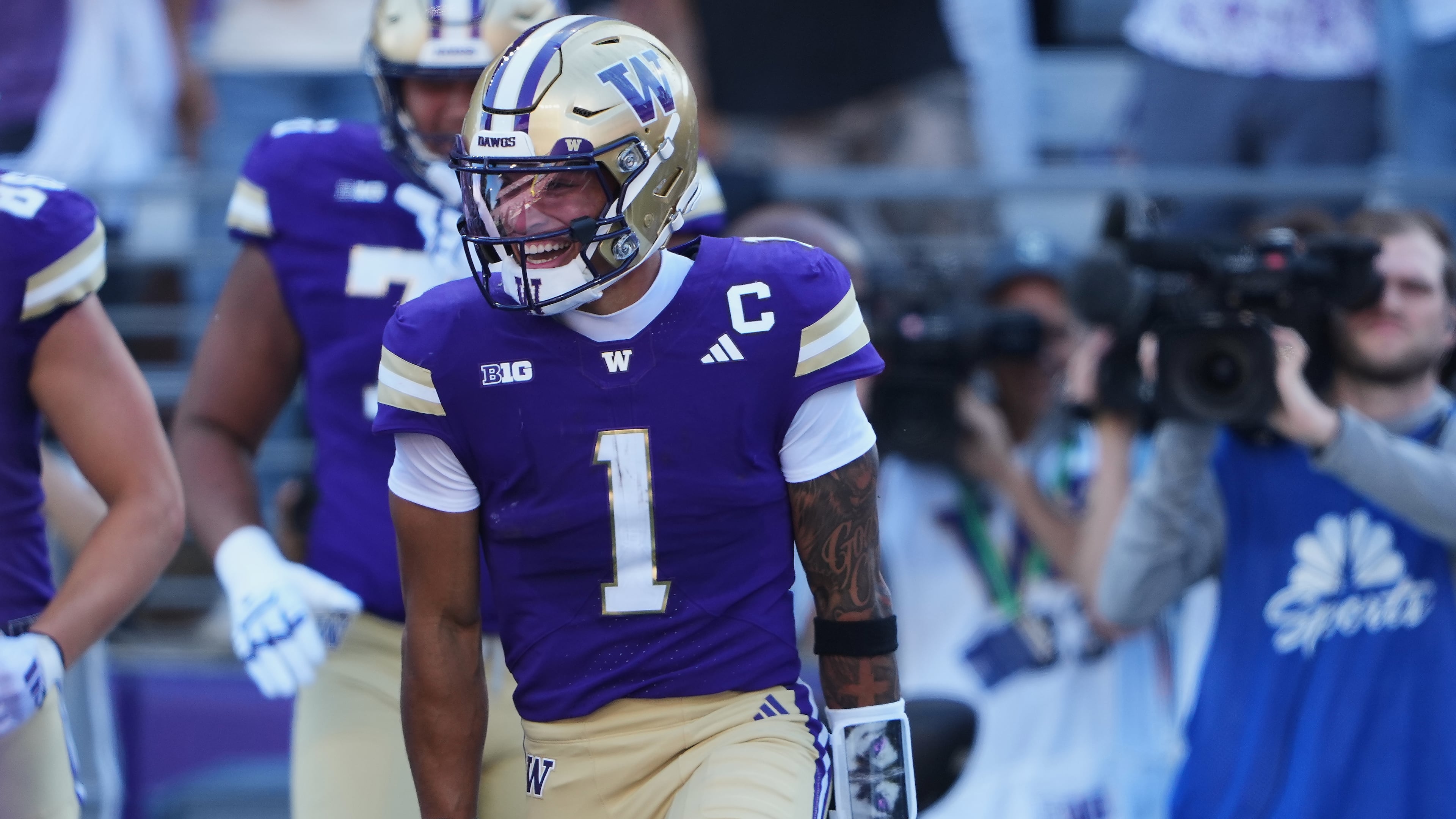 Washington quarterback Demond Williams Jr. celebrates scoring a touchdown against Washington State during the first half of an NCAA college football game, Sunday, Sept. 6, 2026, in Seattle. (AP Photo/Lindsey Wasson)