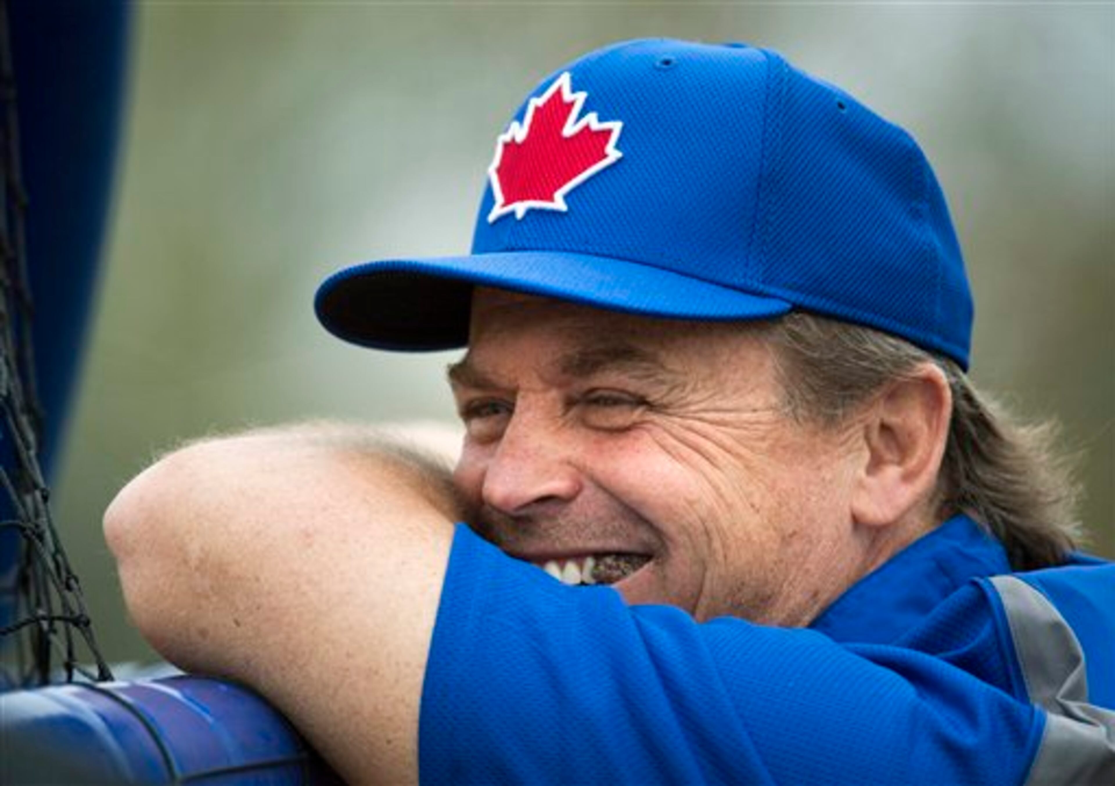 Toronto Blue Jays manager John Gibbons laughs while watching batting practice during baseball spring training in Dunedin, Fla., on Wednesday, Feb. 20, 2013. (AP Photo/The Canadian Press, Nathan Denette)