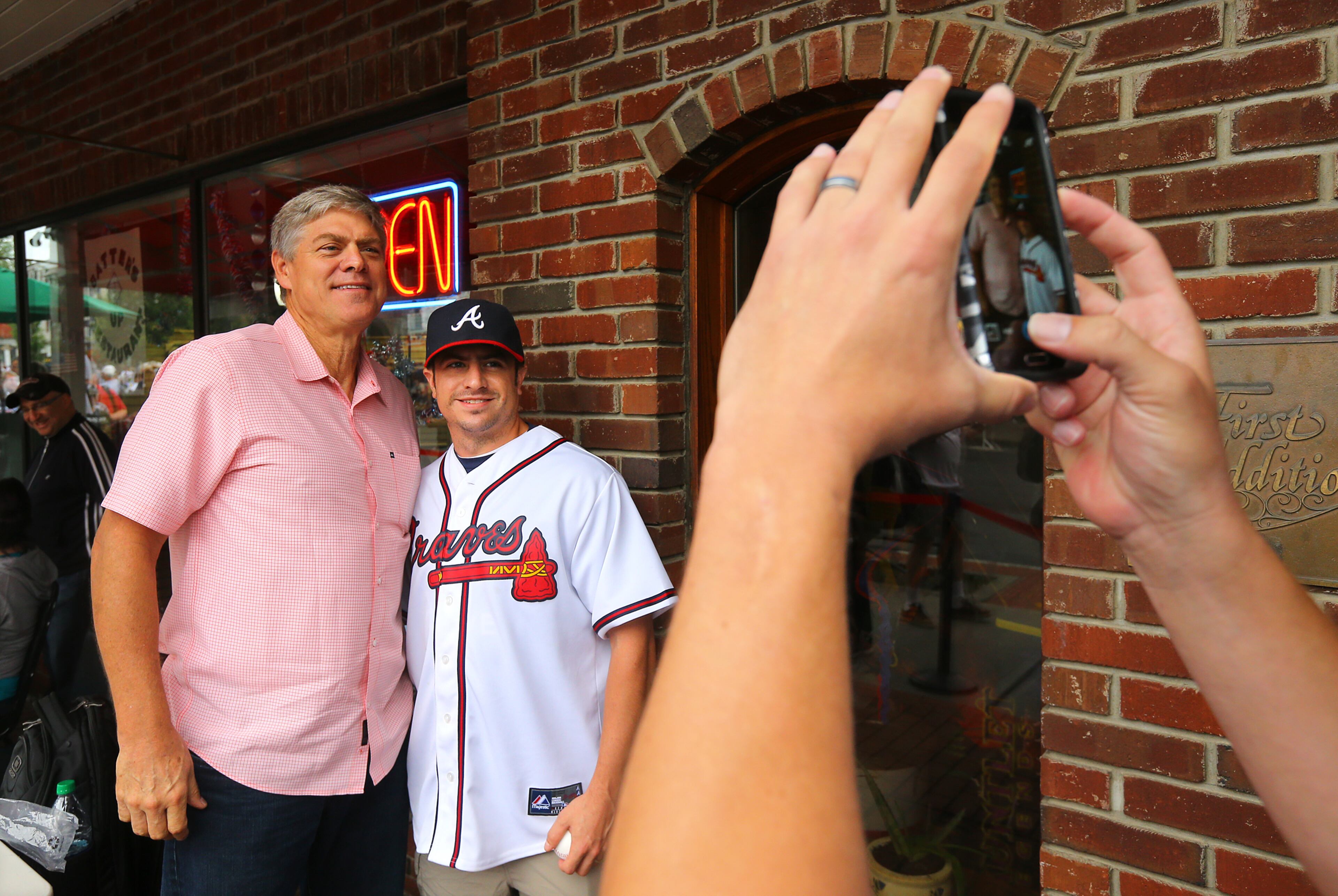 Braves fan Zac Tokos has his picture taken with Dale Murphy after getting his autograph on Main Street on Sunday, July 27, 2014, in Cooperstown.