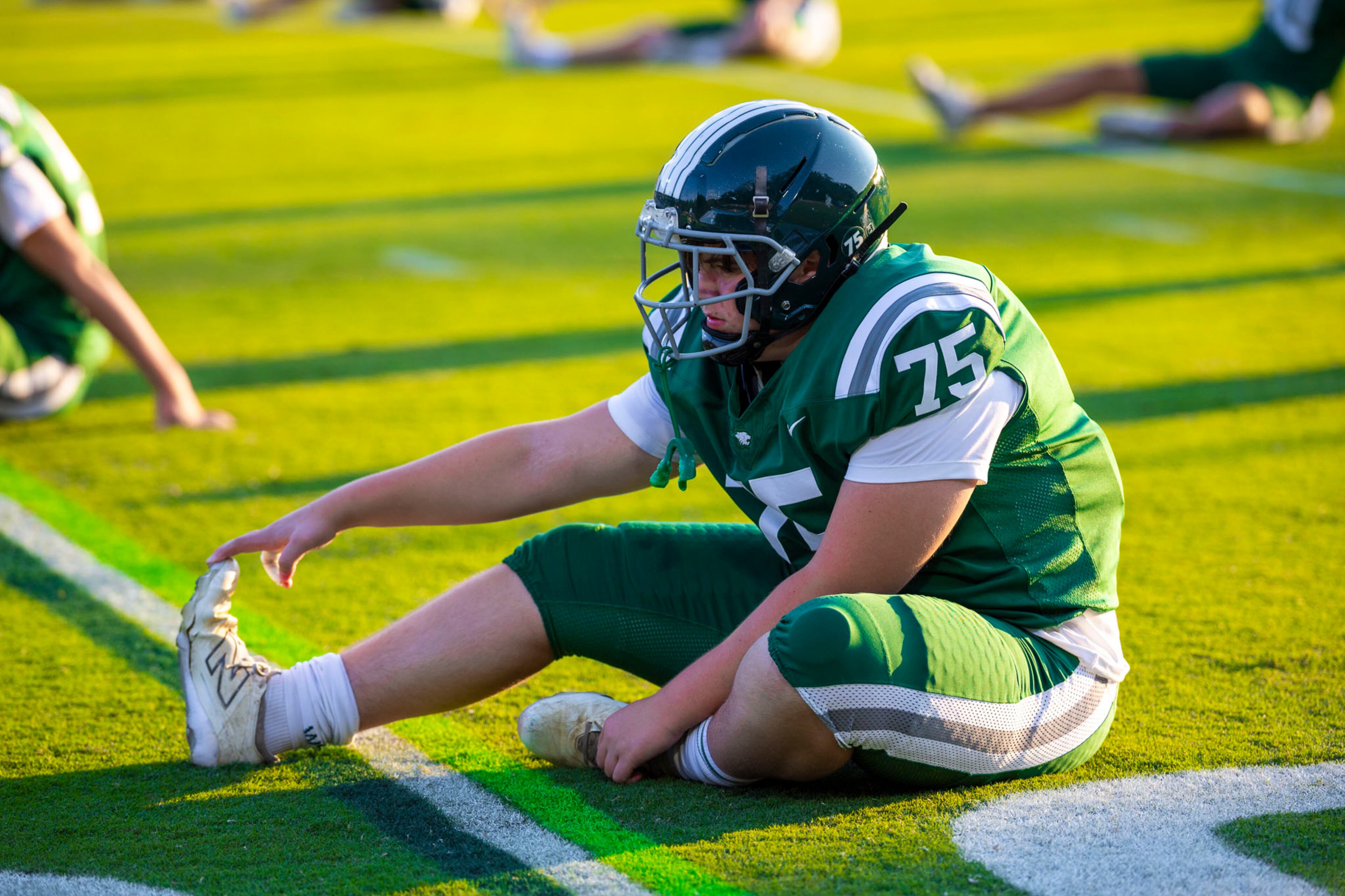 Westminster tackle Alex Pope (75) stretches prior to a football game against Benedictine at Fritz Orr Field in Atlanta, GA on Friday, Sept. 19th, 2025. (Oscar Guevara Saenz for the AJC)
