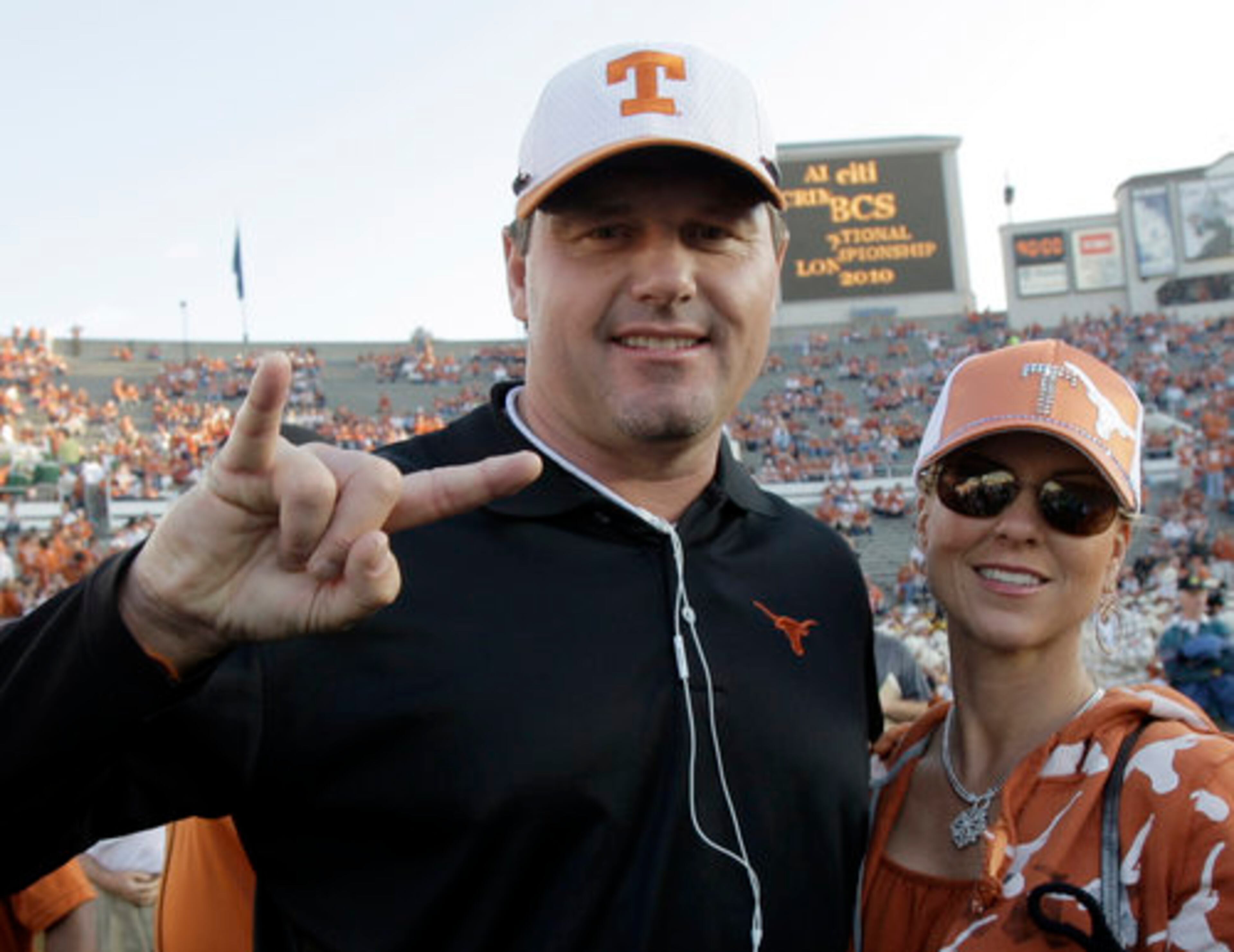 Former major league pitcher Roger Clemens poses with his wife, Debra before the game. Clemens played at Texas.
