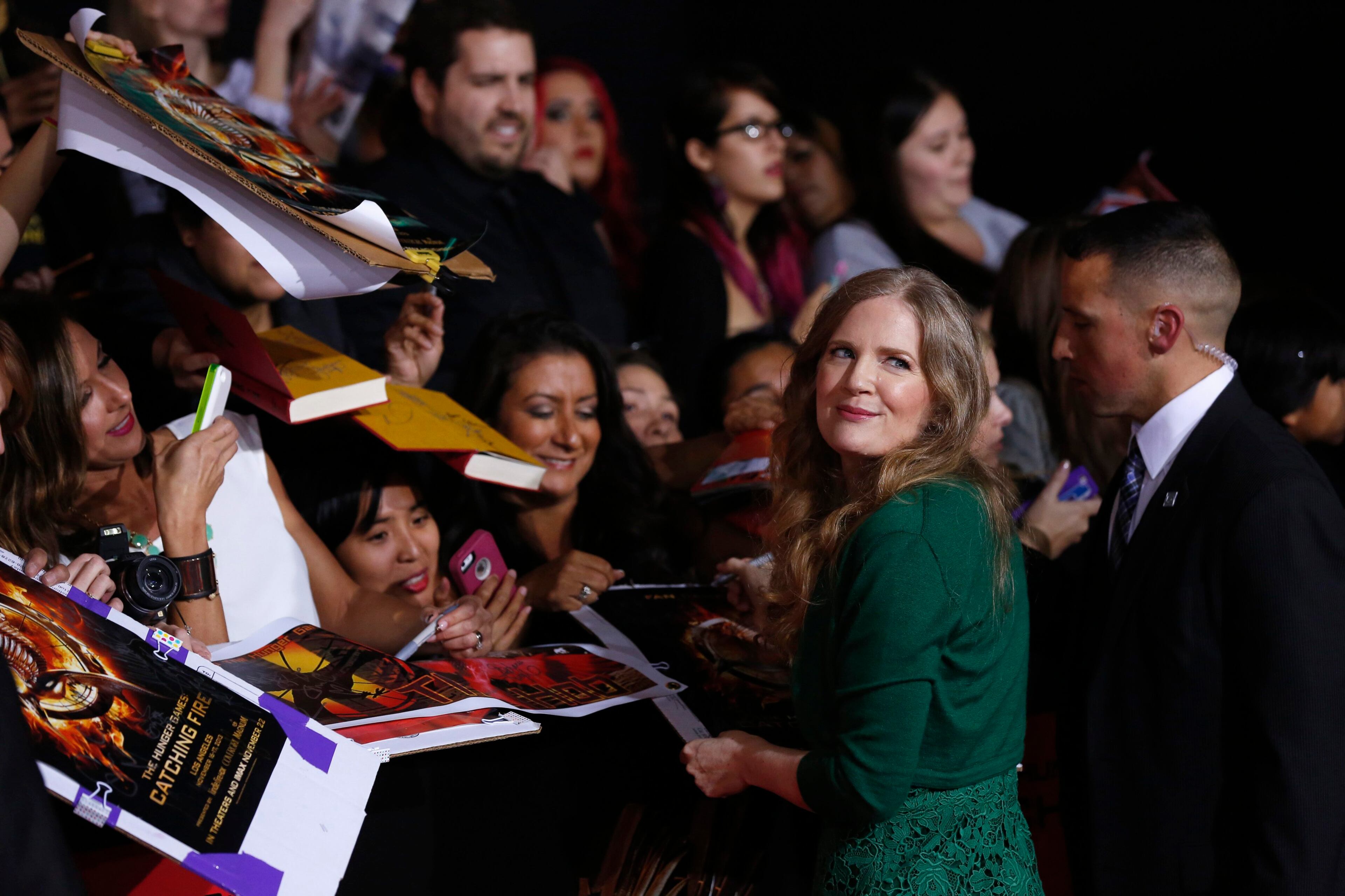 Writer Suzanne Collins signs autographs at the premiere of "The Hunger Games: Catching Fire" in Los Angeles, California November 18, 2013. The movie opens in the U.S. on November 22. REUTERS/Mario Anzuoni