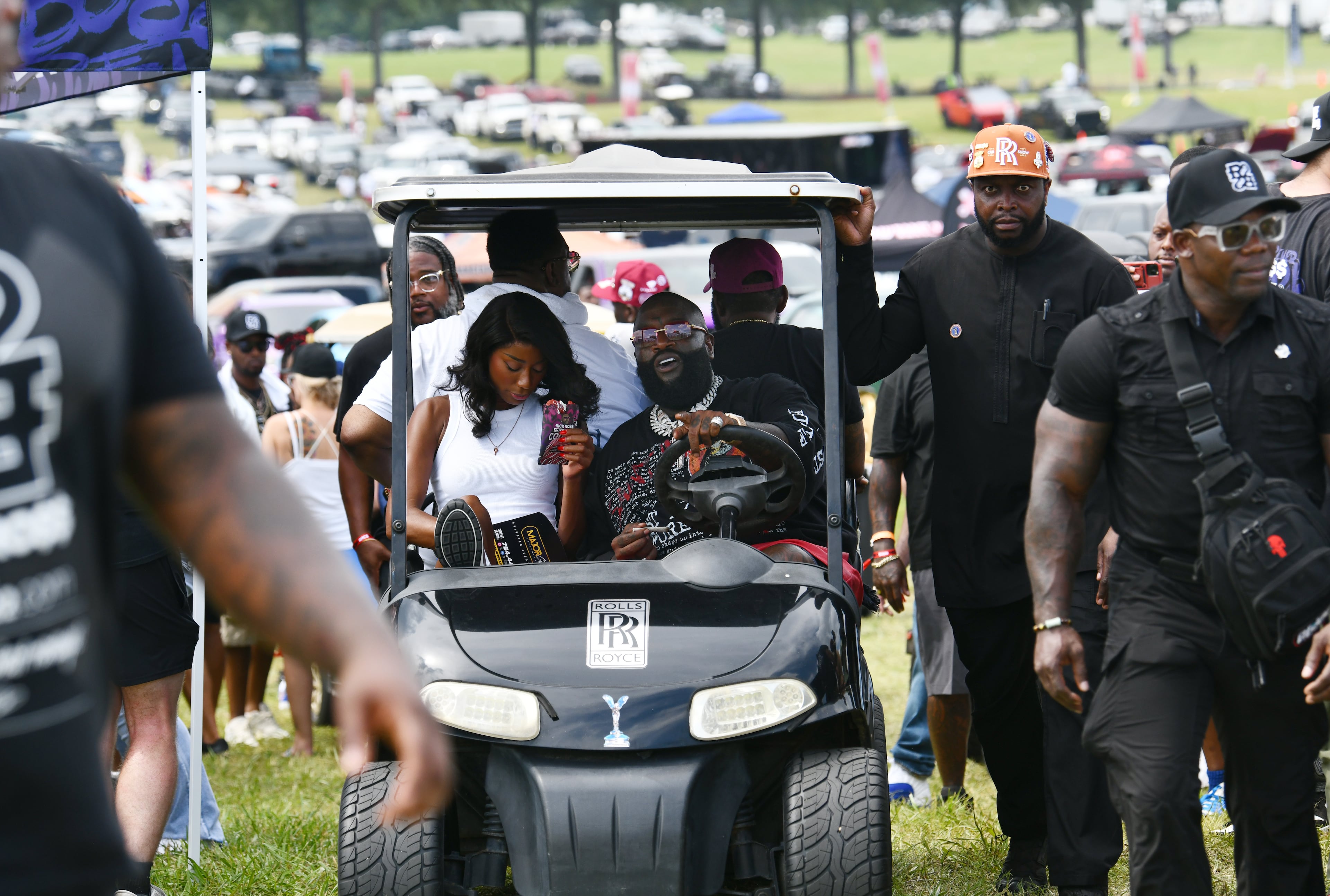 Rick Ross drives his golf cart during the 4th Annual Rick Ross Car and Bike Show, Saturday, June 7, 2025, in Fayetteville. The 4th Annual Rick Ross Car and Bike Show will include a vendor market with more than 30 vendors, food trucks, fleets of classic/custom automobiles, luxury vehicles, boats, RVs and trailers on the front of the mansion. Stage performances include Plies, Ross' new signee Nino Breeze and Ross himself. (Hyosub Shin / AJC)