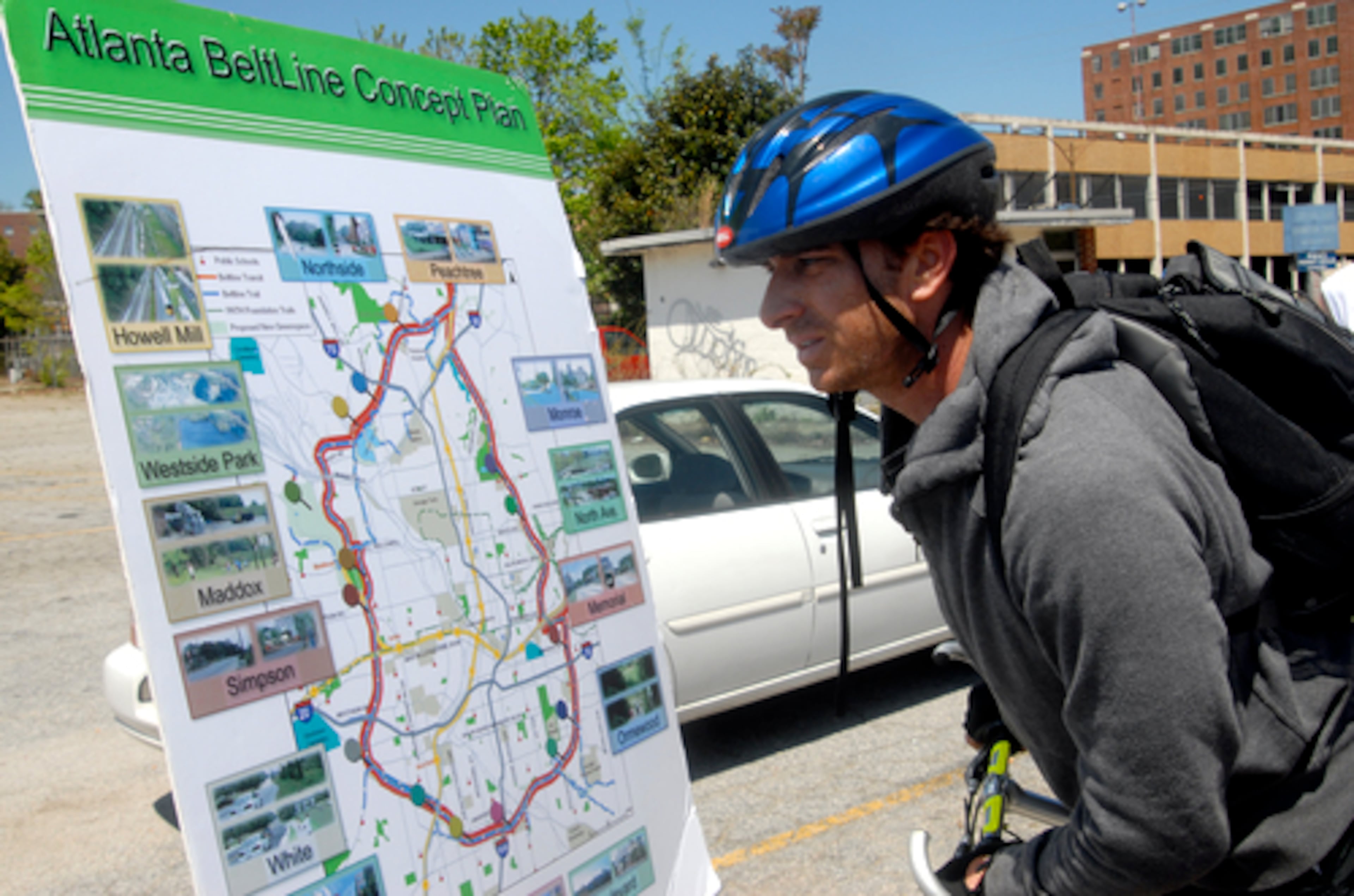 Bryan Alper takes a look at a Beltline concept plan before the start of the ride.