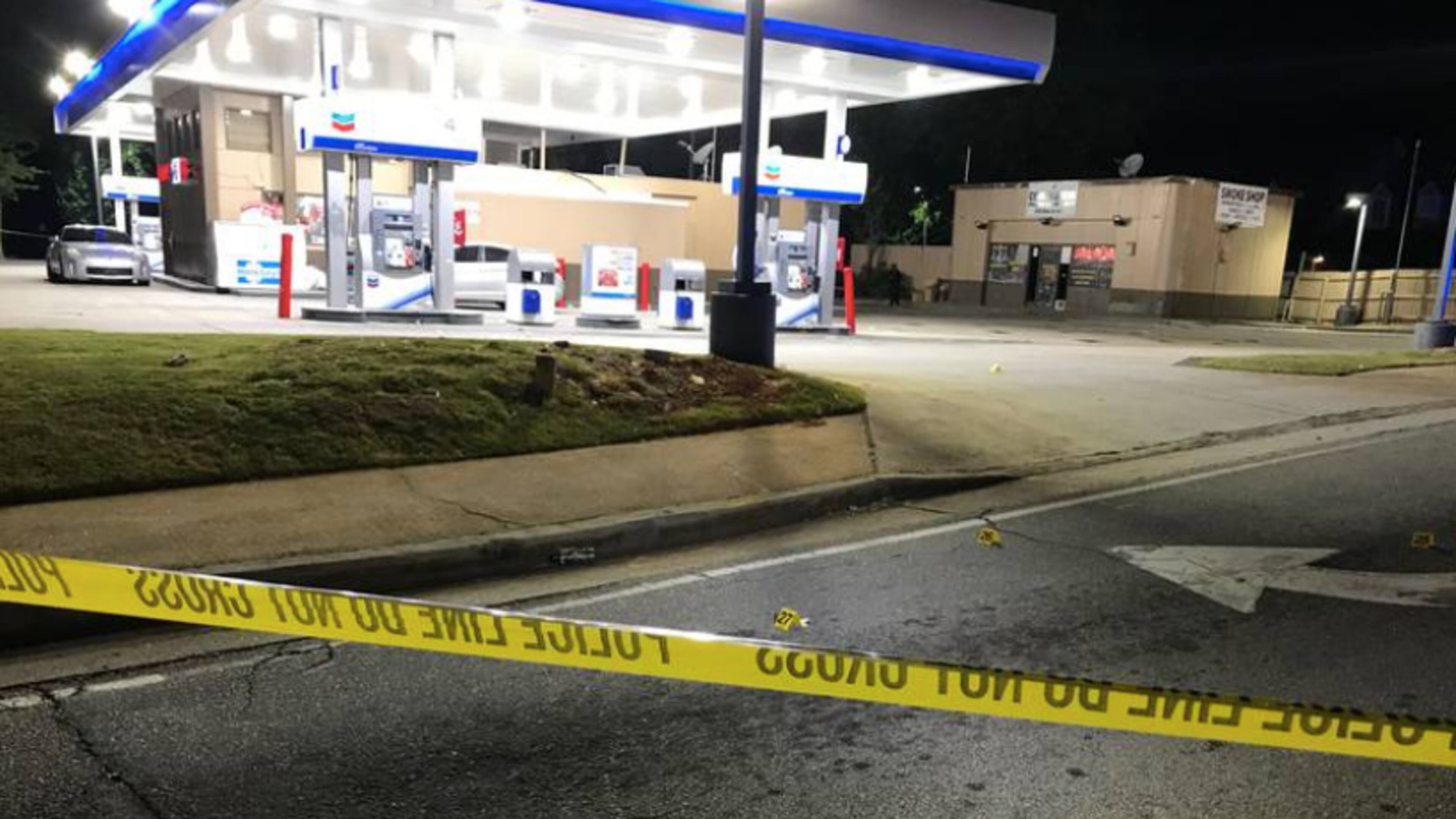 Investigators said a gunman began firing into a crowd of people outside a Chevron station, which is near a smoke shop.