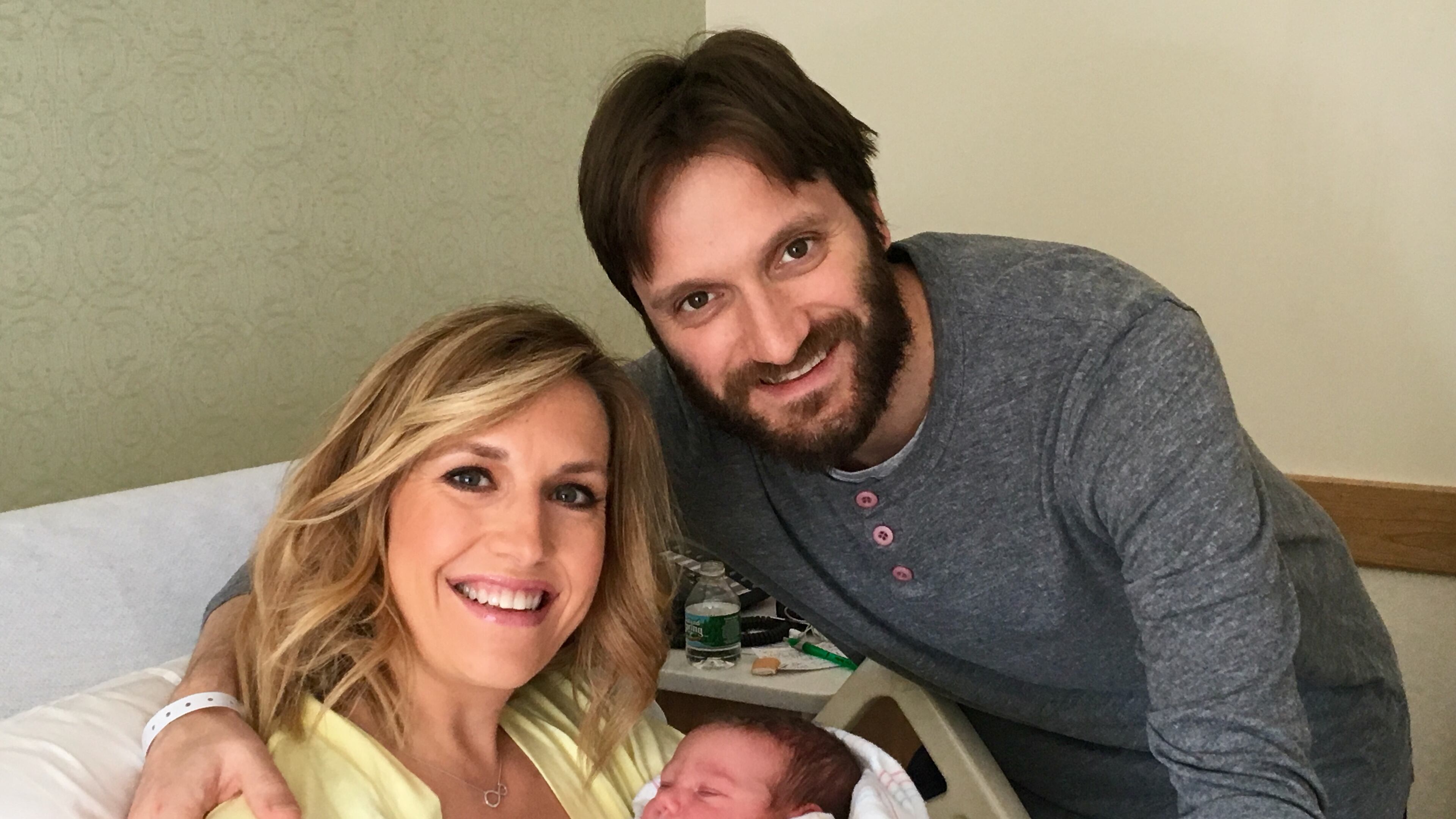 Poppy Harlow, new daughter Sienna and husband Sinisa Babcic. CREDIT: CNN