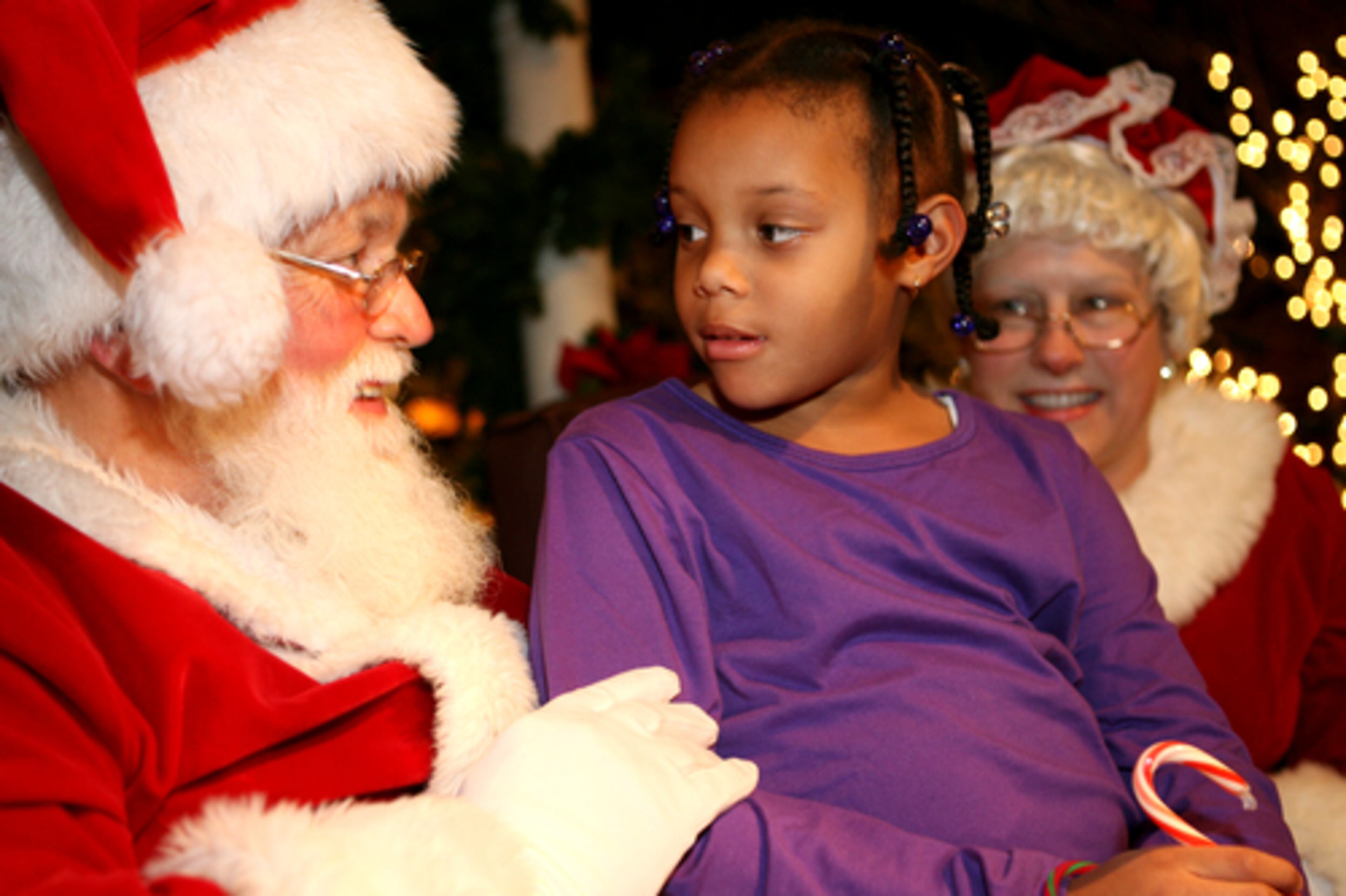 And no tree lighting is complete without the man in the red suit. Seven-year-old Grace Fabio asks Santa and Mrs. Claus (Mike and Karen Vaughan) for an American Girl Doll for Christmas.