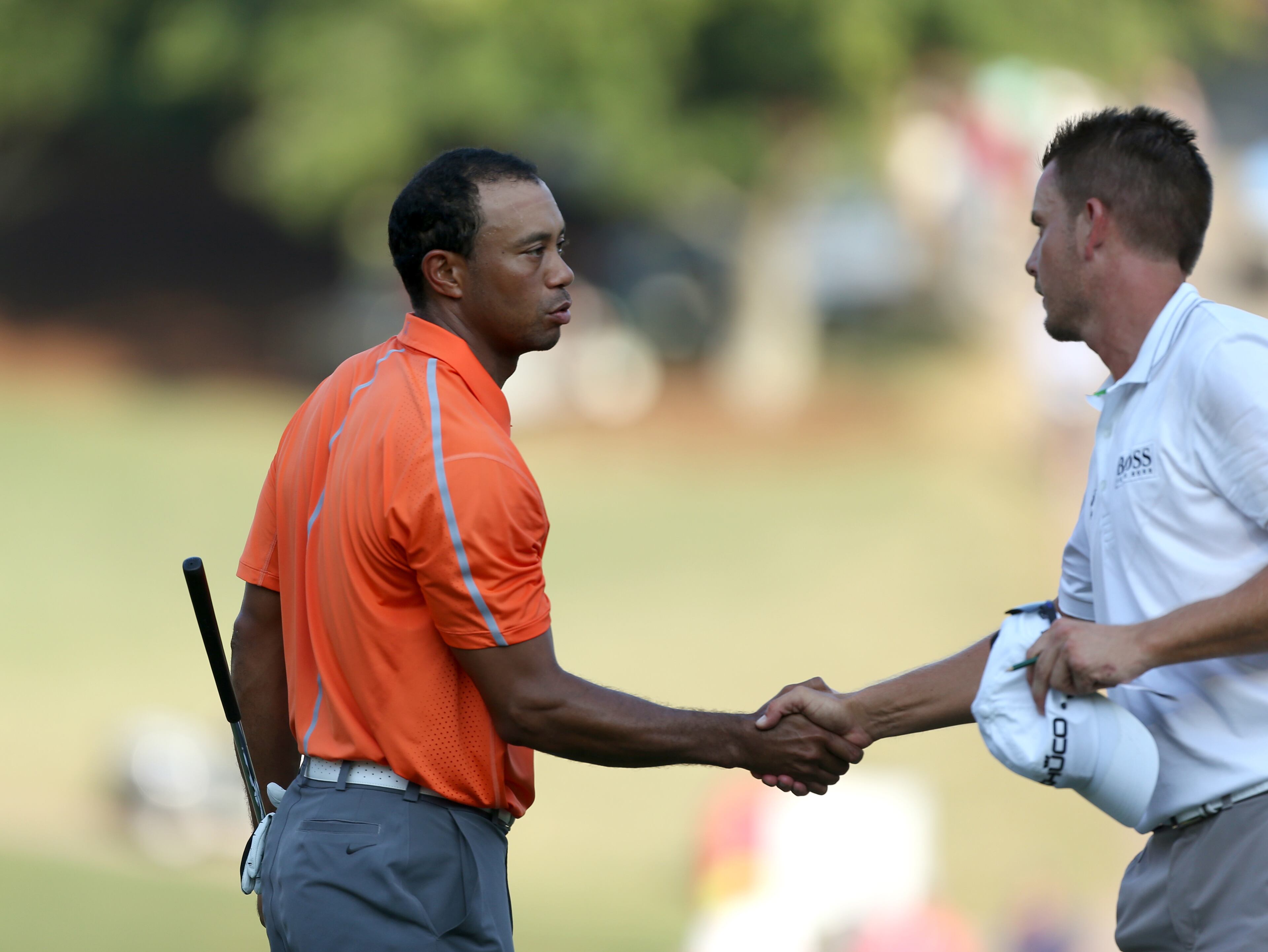 Tiger Woods, left, congratulates playing partner Henrik Stenson following their finish on No. 18 green during round one of the 2013 Tour Championship at East Lake Golf Club Thursday morning in Atlanta, Ga., September 19, 2013. Woods finished in 29th place with a round of 3 over par.