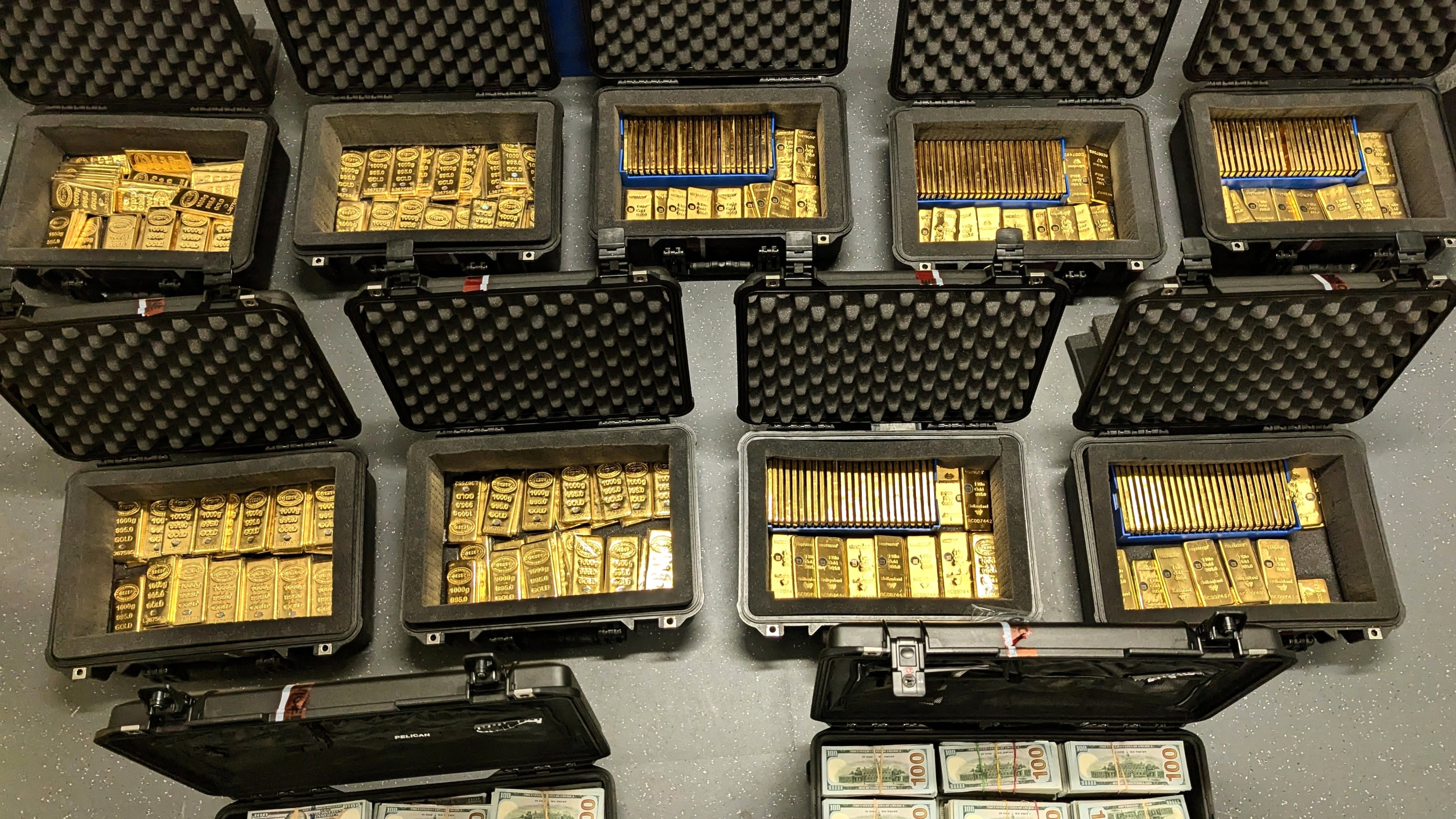 This image provided by U.S. Department of Justice, and contained in a court filing, shows gold bars and cash that was seized from a David J. Rush's home, during a search on May 19, 2026, in Ashburn, Va. (AP Photo/Justice Department via AP)