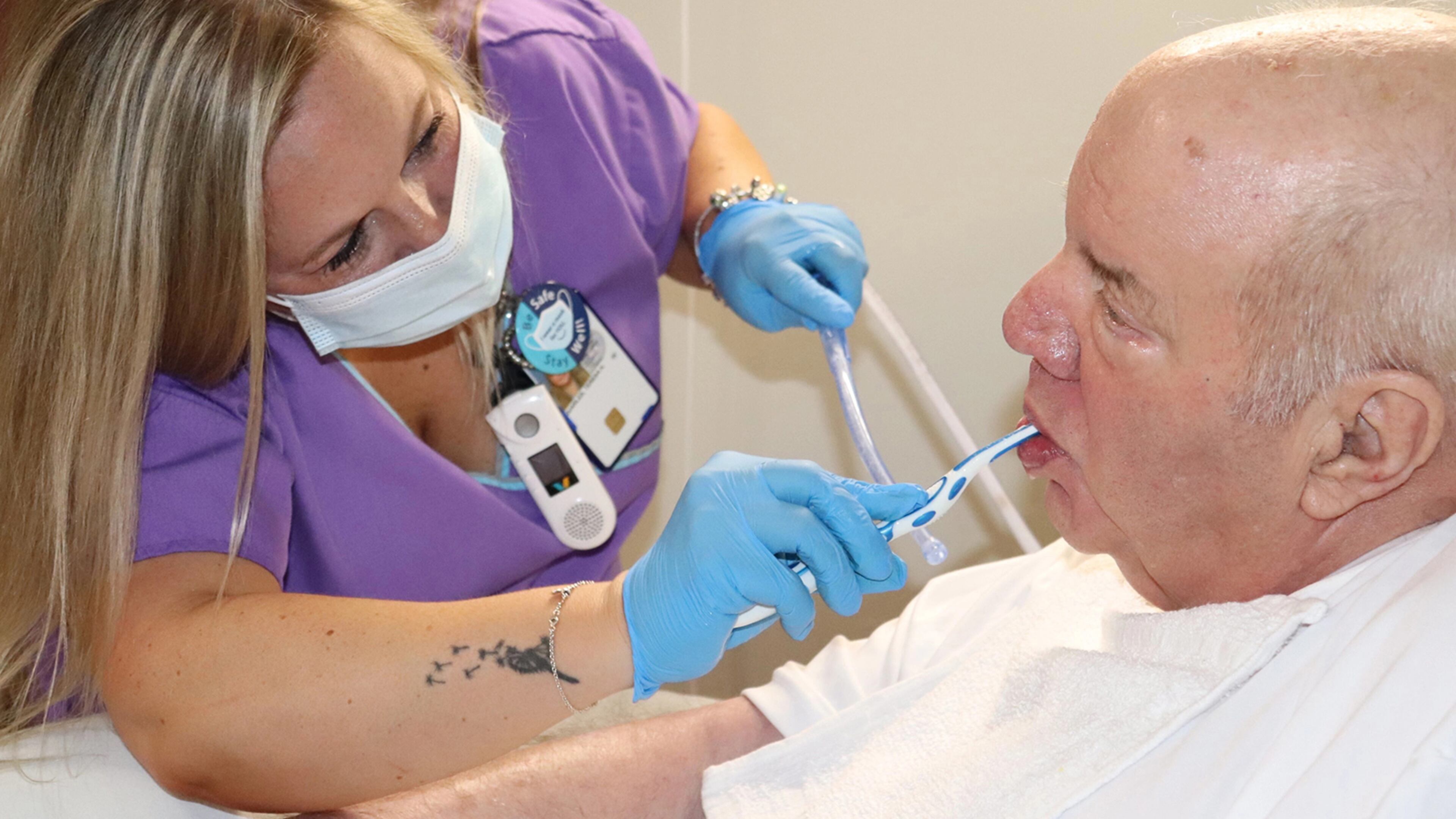 James Massie, an Army veteran and a patient at the Salem Veterans Affairs Medical Center in Salem, Virginia, gets his teeth brushed by nursing assistant Teresa Quarles in June. (Rosaire Bushey/KHN/TNS)