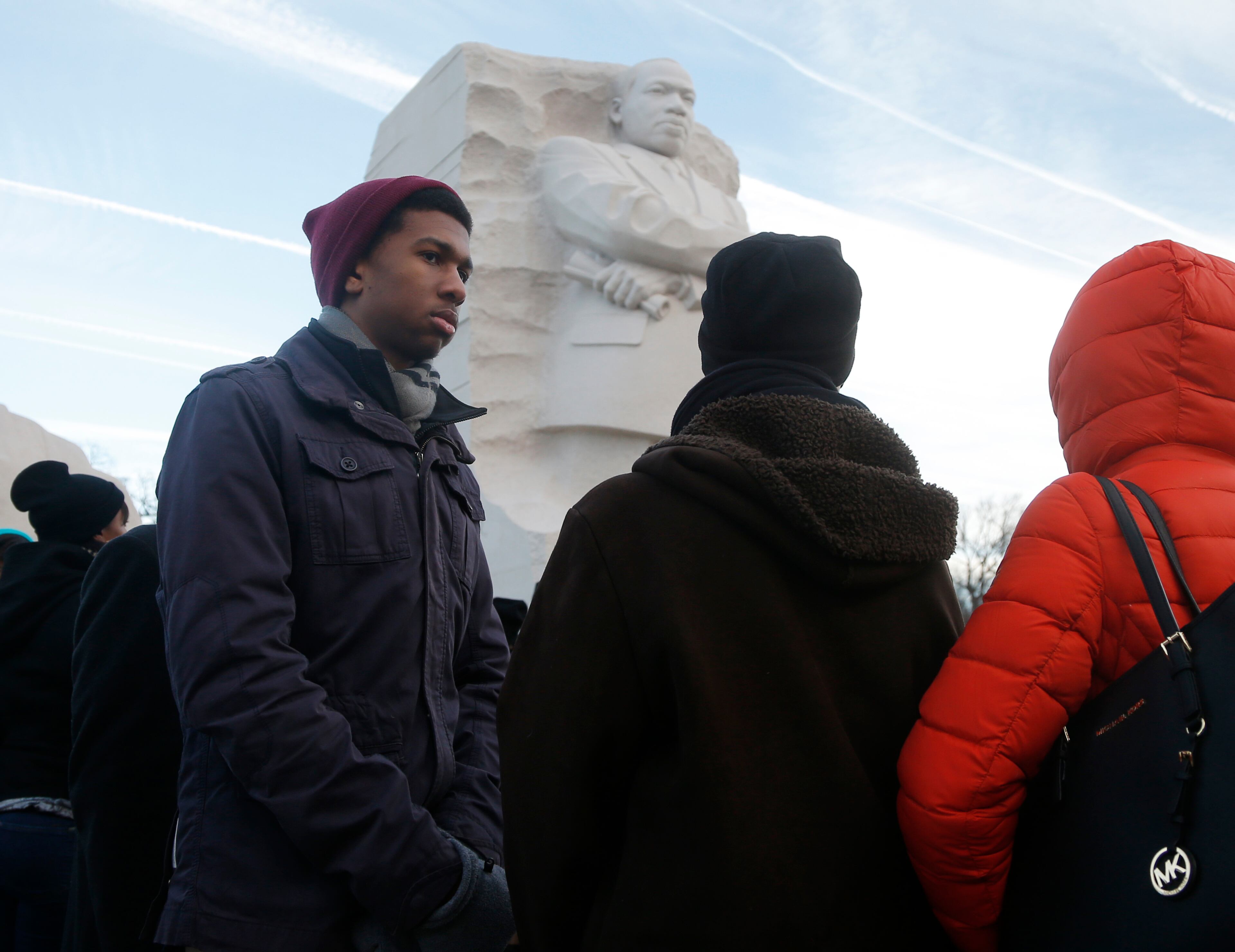 Tanner Williams, left, from Silver Spring, Md., stands with his mother Julie, center, and sister Kira, right, during a wreath laying at the Martin Luther King Jr. Memorial in Washington, Monday, Jan. 20, 2014. The nation paused to remember Martin Luther King Jr. Monday with parades, marches and service projects. King was born Jan. 15, 1929, and the federal holiday is the third Monday in January.