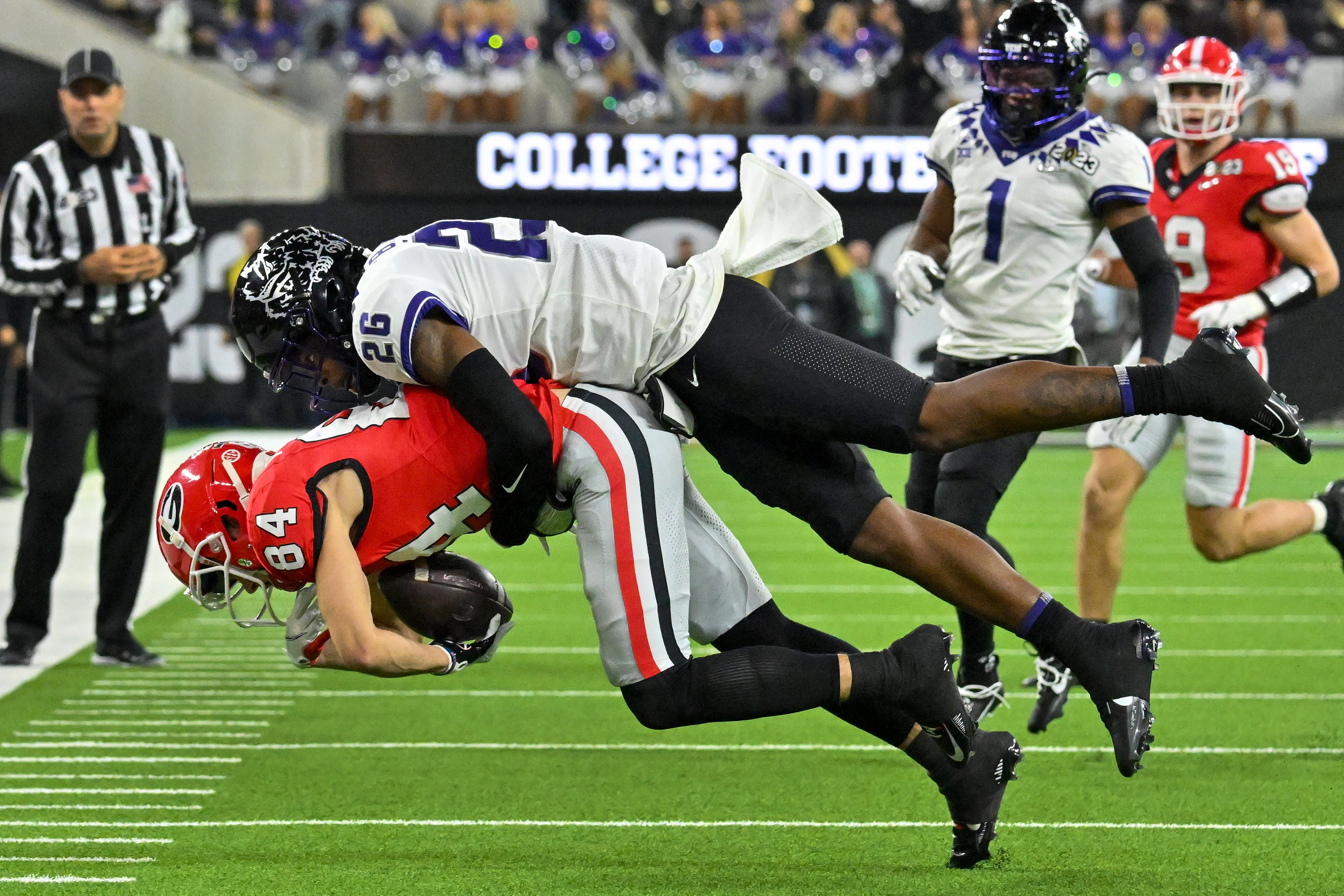 Georgia Bulldogs wide receiver Ladd McConkey (84) catches a pass in front of TCU Horned Frogs safety Bud Clark (26) during the first half of the College Football Playoff National Championship at SoFi Stadium in Los Angeles on Monday, January 9, 2023. (Hyosub Shin / Hyosub.Shin@ajc.com)