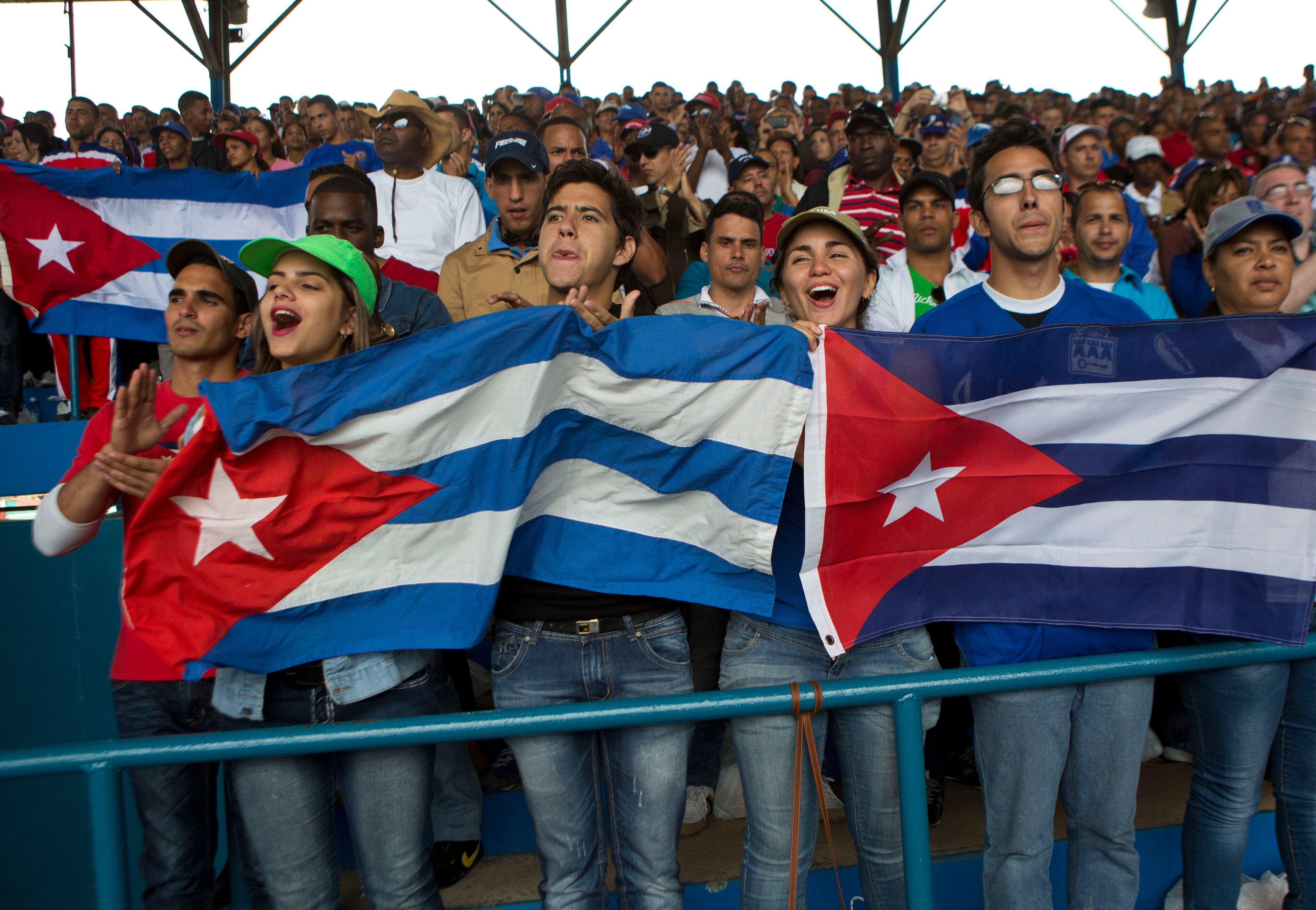 Cuban fans cheer during the game in Havana, Cuba. It's the first game featuring an MLB team in Cuba since the Baltimore Orioles played in the country in 1999. (AP Photo/Rebecca Blackwell)