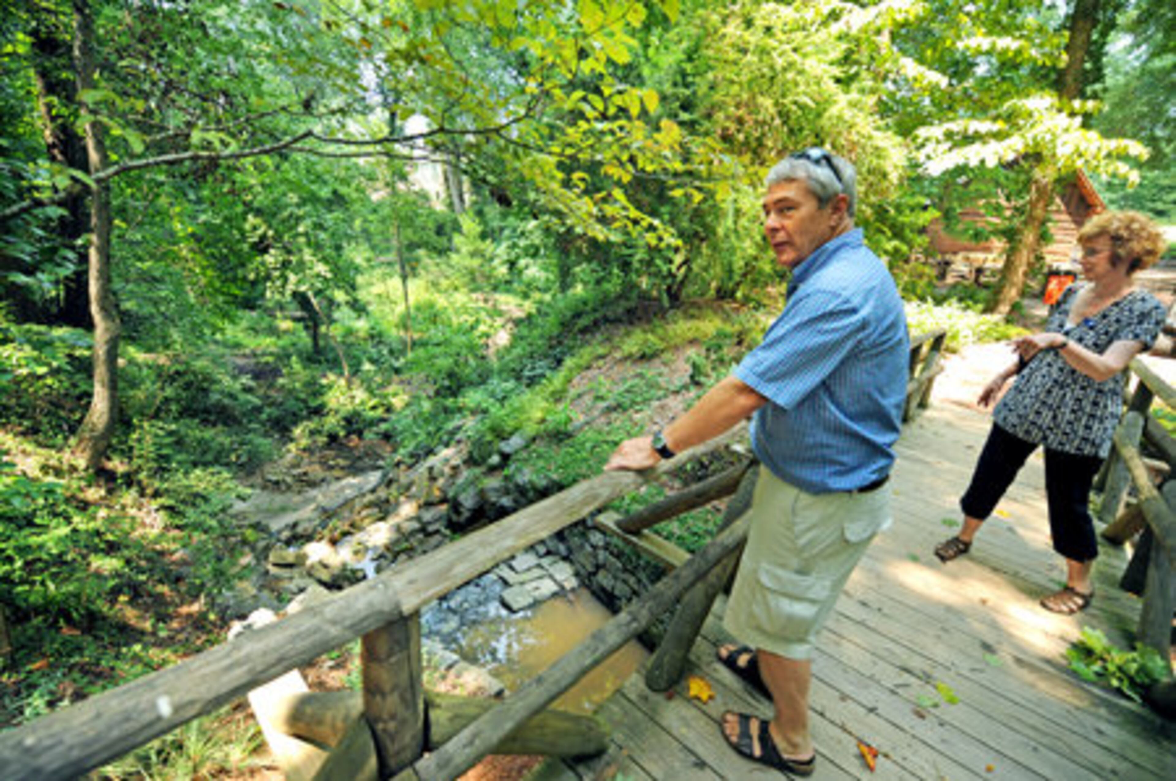 Gordon Kent and Rebecca DaSilva stand on a bridge overlooking the Quarry Garden at The Atlanta History Center. The 3-acre garden has the state's most comprehensive collection of native plants and lies 25 feet below ground in a rock quarry.