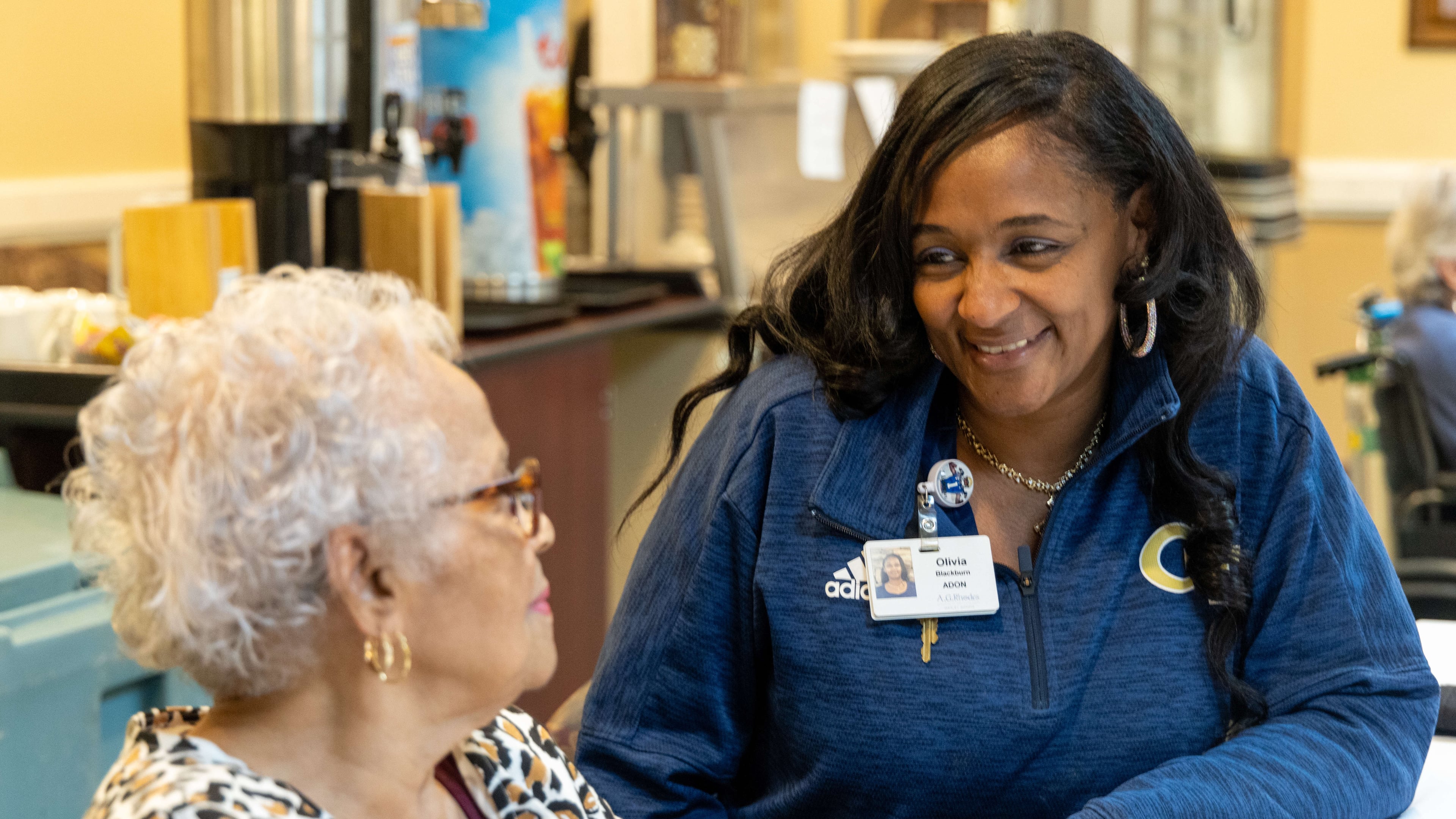 Assistant Director of Nursing Olivia Blackburn chats with resident Ethel Williams during lunch at the A.G. Rhodes Wesley Woods facility in Decatur. PHIL SKINNER FOR THE ATLANTA JOURNAL-CONSTITUTION