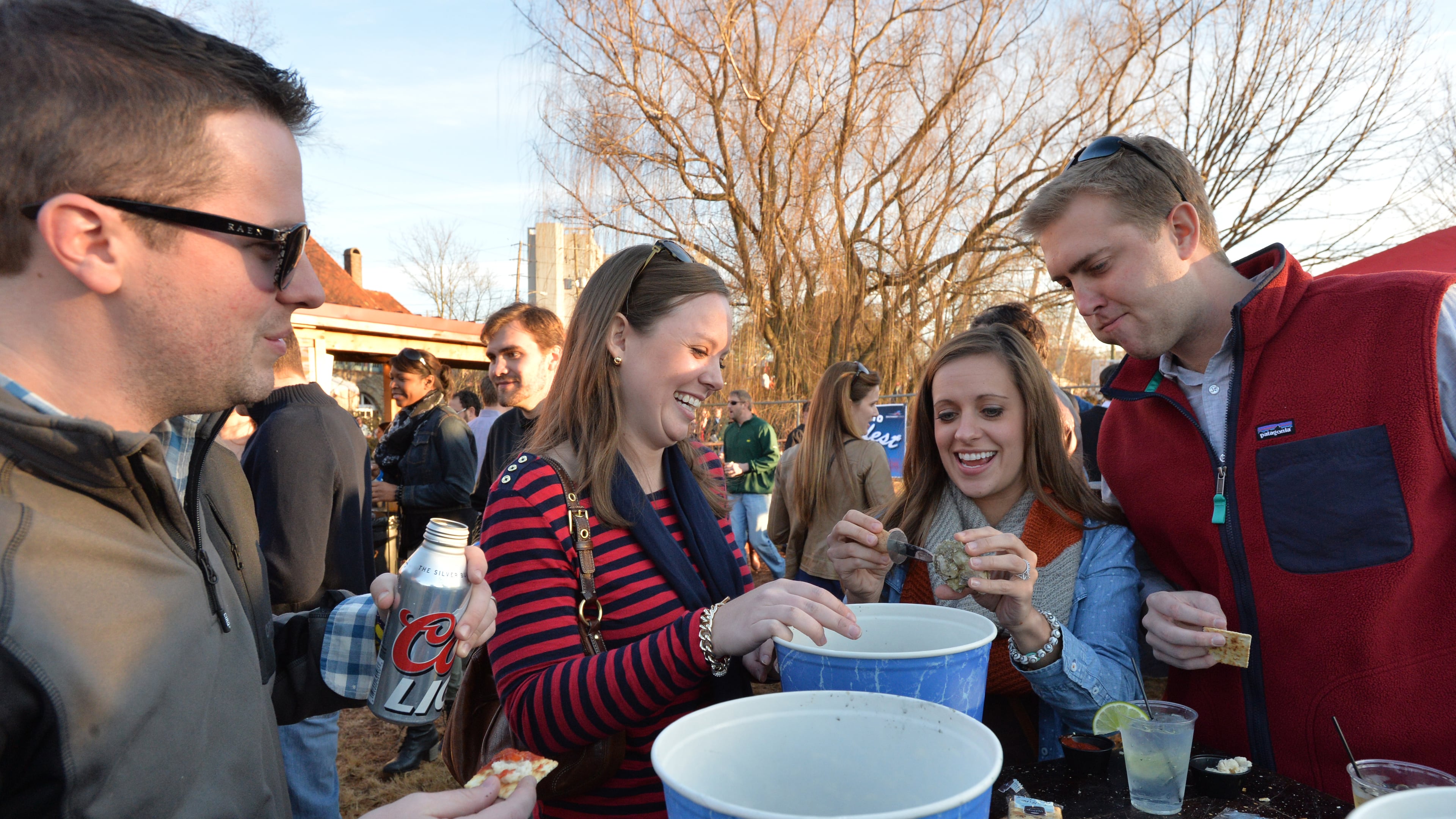 Festival goers (from left) Blake Rouse and his wife Sarah and Emily Randall and her husband Drew enjoy fresh oysters and live musice during Oysterfest 2014 at Park Tavern in Atlanta on Saturday, February 8, 2014. Oysterfest features live music from local bands, DJs, cold beer and other beverages, and tons of fresh raw, steamed, and fried oysters with plenty of cocktail sauce and crackers - all at the Park Tavern in Piedmont Park. The raw oysters are flown in fresh Connecticut (Blue Point Oysters) and Prince Edward Island (Malpeque Oysters) and fried and steamed oysters from straight from the Texas coast. HYOSUB SHIN / HSHIN@AJC.COM