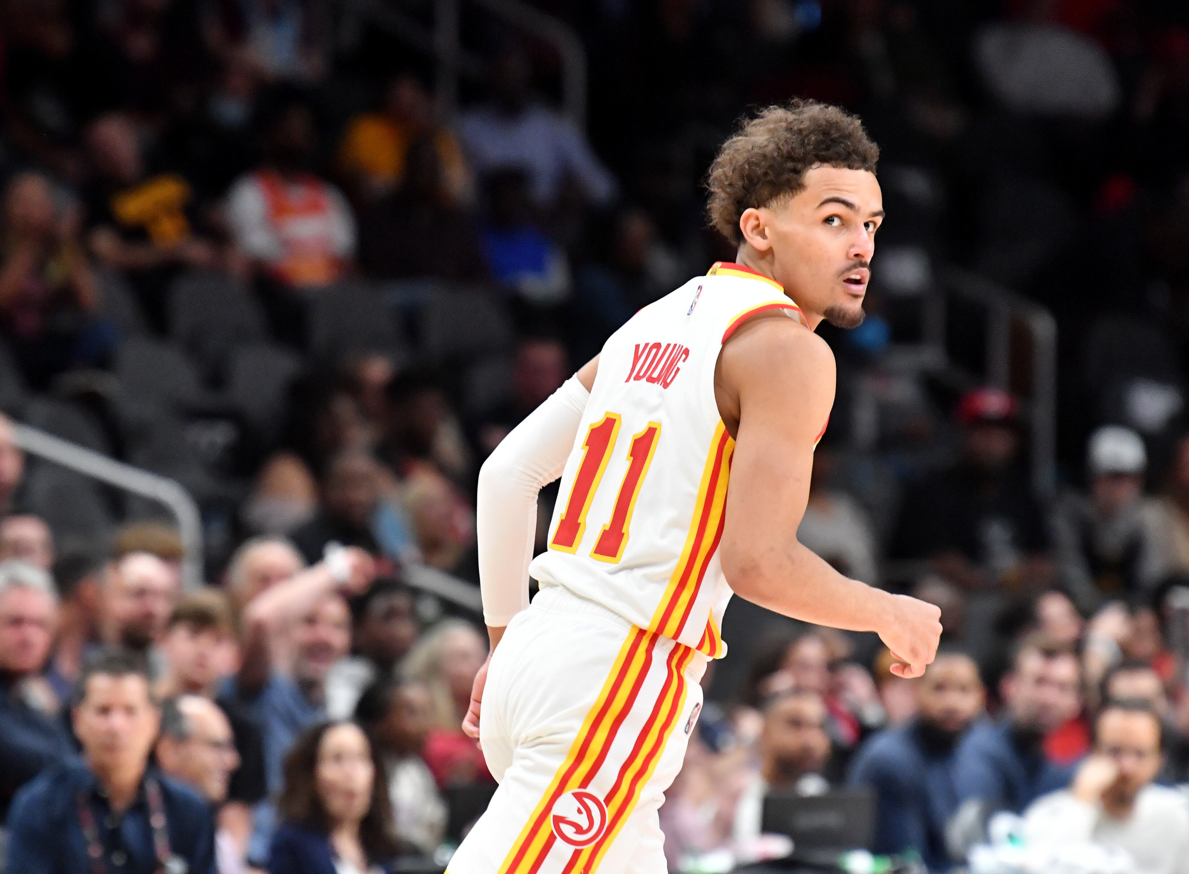 Hawks' guard Trae Young (11) reacts after scoring during the first half in an NBA basketball game at State Farm Arena on Thursday, March 31, 2022. Atlanta Hawks won 131-107 over Cleveland Cavaliers. (Hyosub Shin / Hyosub.Shin@ajc.com)