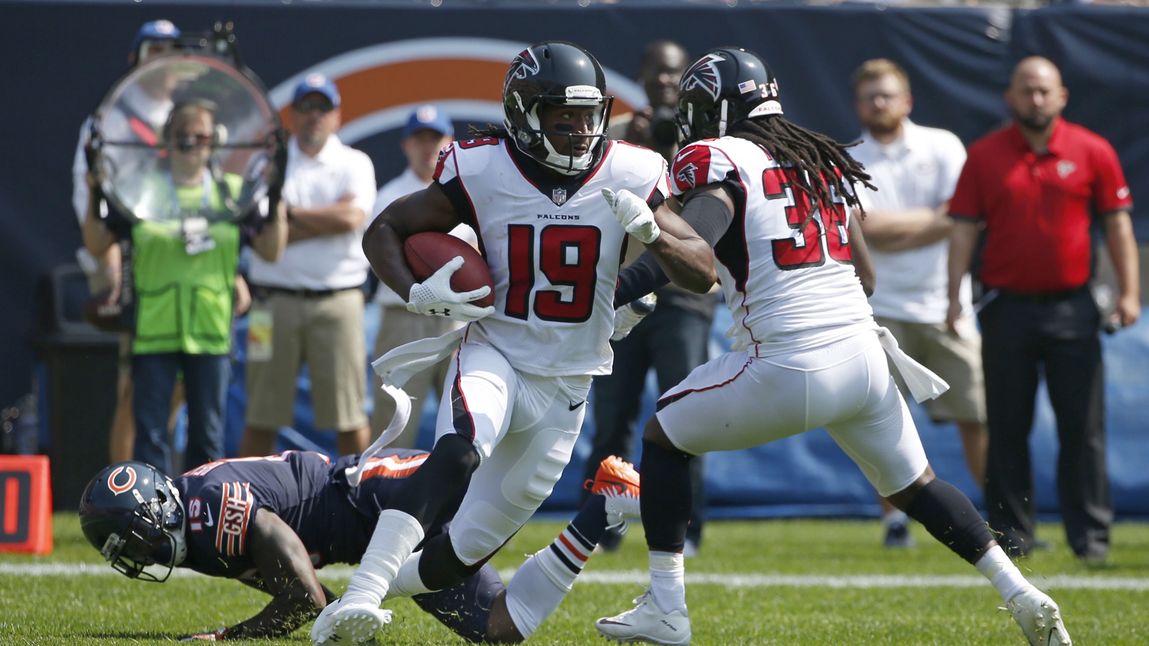 Atlanta Falcons' Andre Roberts (19) returns the opening kickoff during the first half of an NFL football game against the Chicago Bears, Sunday, Sept. 10, 2017, in Chicago. Chicago's Josh Bellamy is on the ground after being blocked in the back by Atlanta's Kemal Ishmael. (AP Photo/Nam Y. Huh)