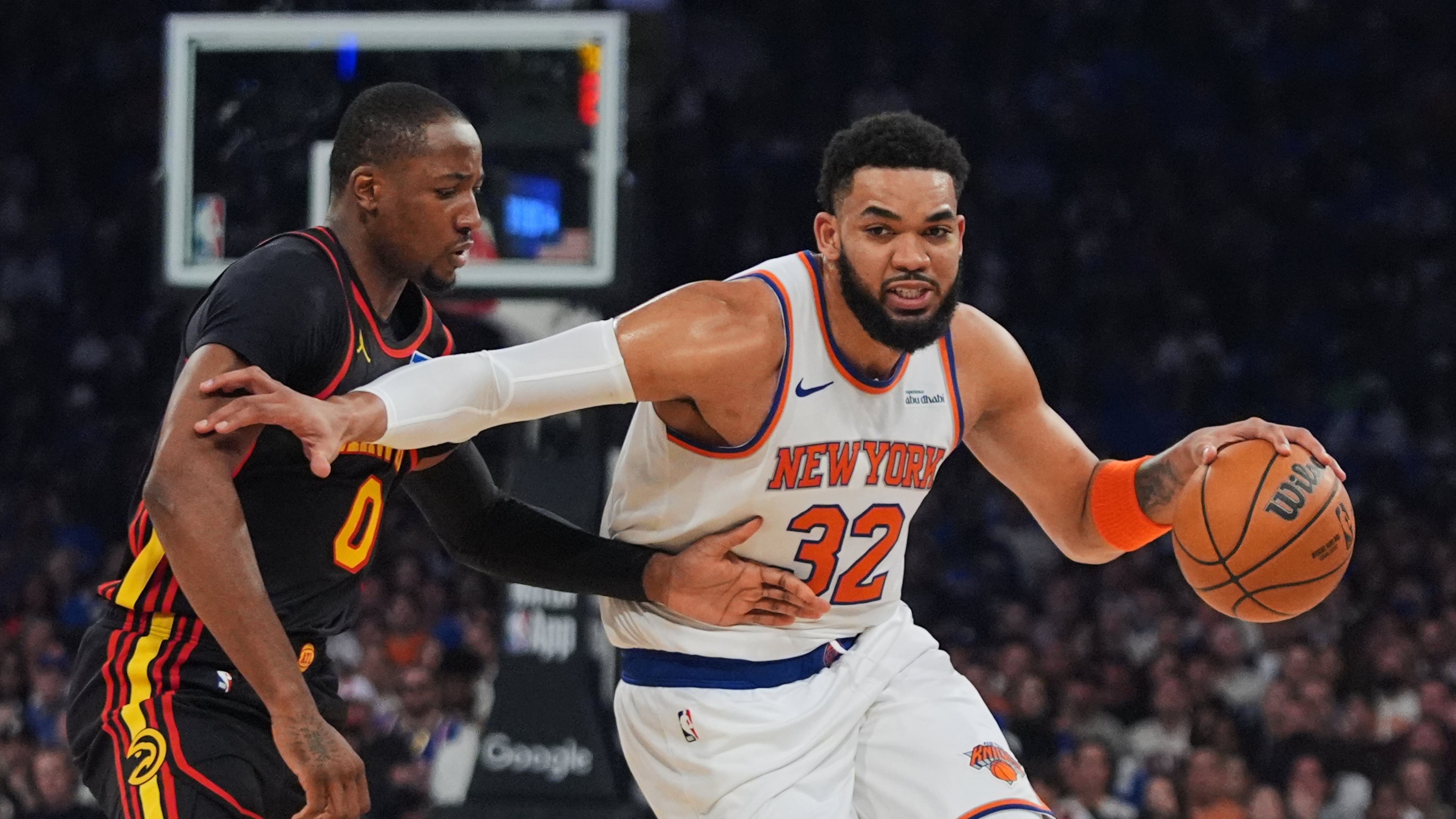 The Knicks' Karl-Anthony Towns (right) drives past the Hawks' Jonathan Kuminga during the first half in Game 1 of their first-round playoff series Saturday, April 18, 2026, in New York. (Frank Franklin II/AP)