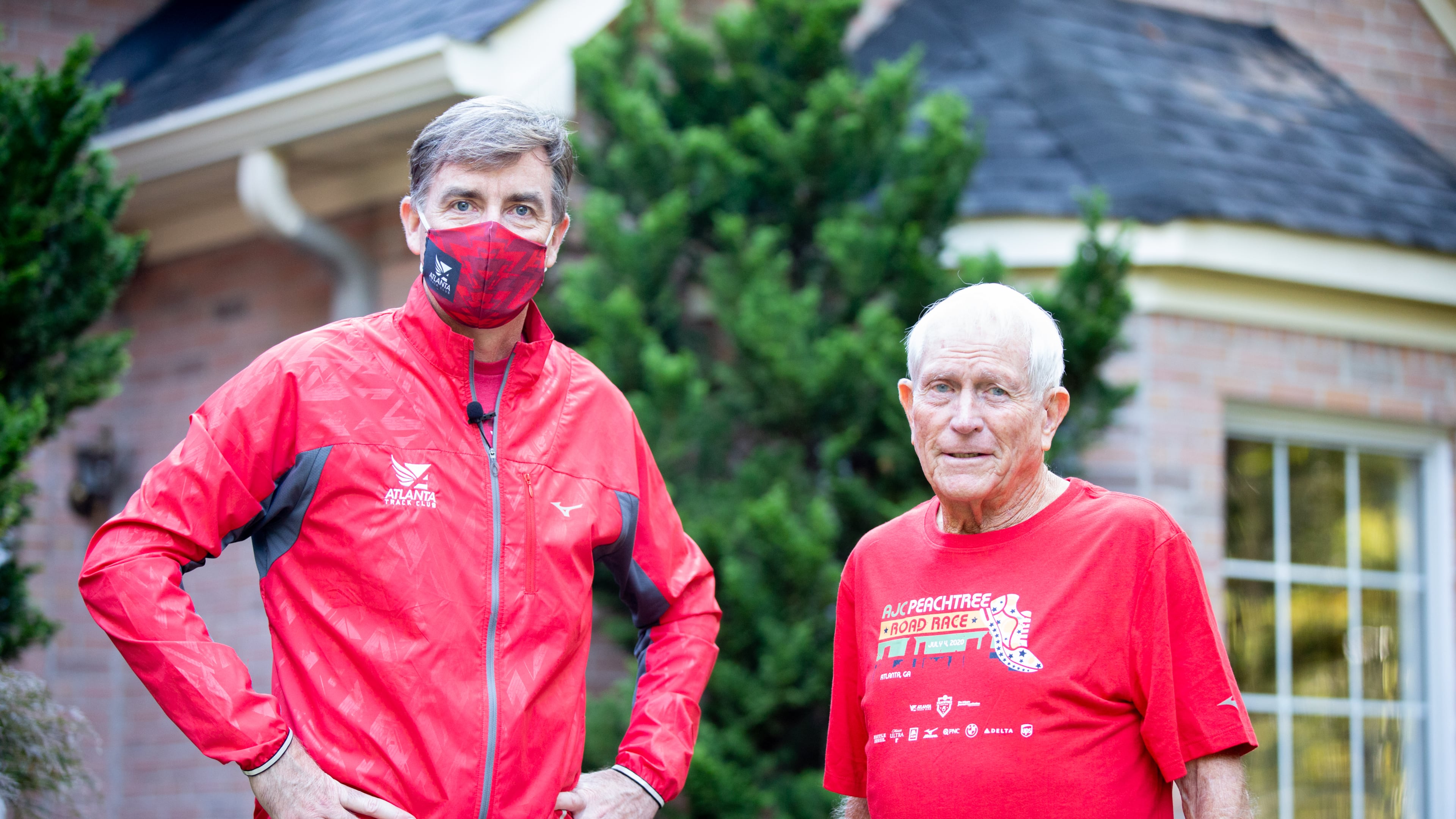 Rich Kenah, executive director of Atlanta Track Club, poses for a photo with Bill Thorn in Tyrone, Georgia, on Tuesday, October 13, 2020. Bill Thorn was presented the t-shirt for the annual Peachtree Road Race on Tuesday by the Atlanta Track Club. (Photo/Rebecca Wright for the Atlanta Journal-Constitution)