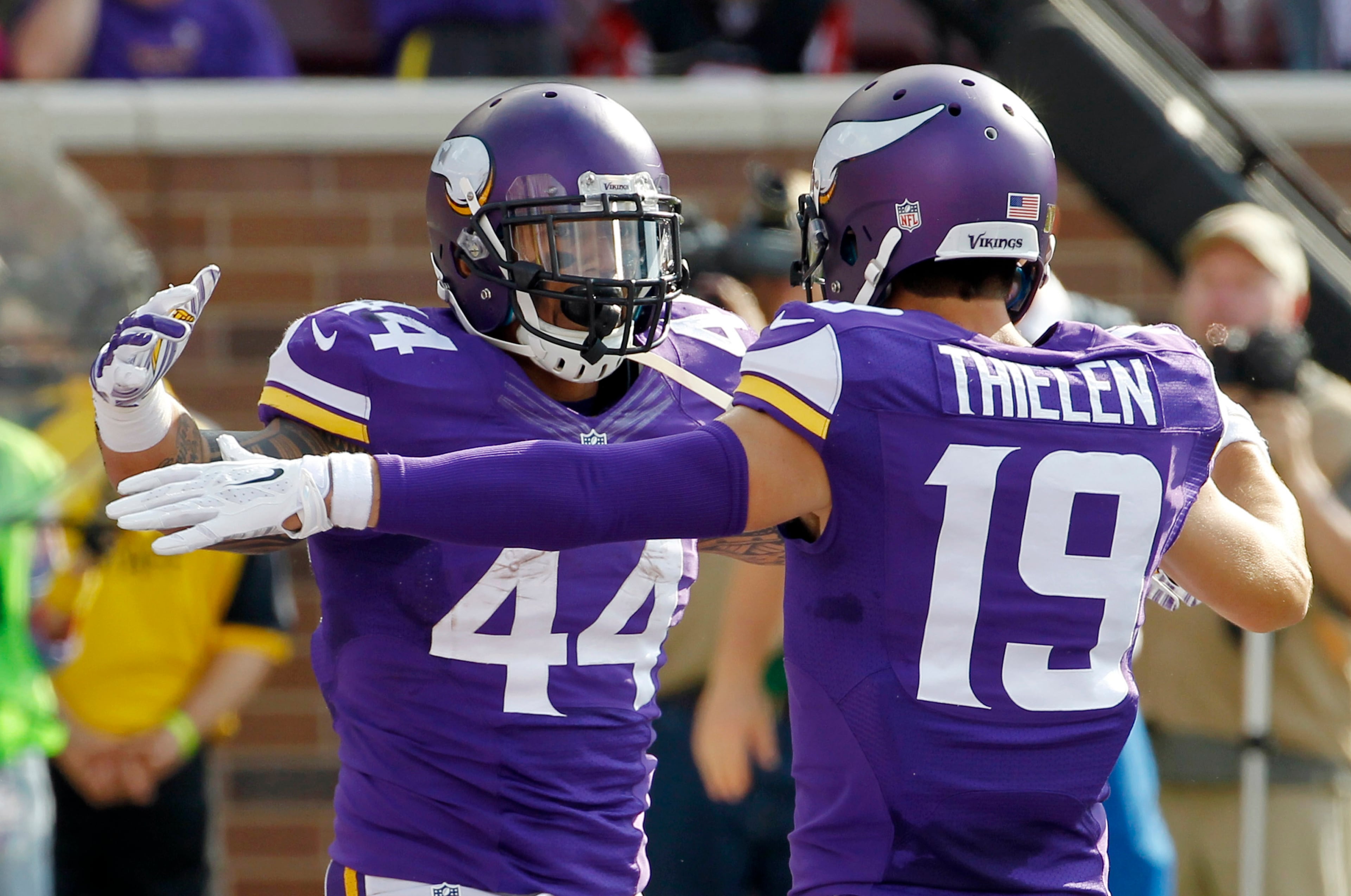 Minnesota Vikings running back Matt Asiata, left, celebrates with teammate Adam Thielen after scoring on a 3-yard touchdown run during the first half of an NFL football game against the Atlanta Falcons, Sunday, Sept. 28, 2014, in Minneapolis. (AP Photo/Ann Heisenfelt)