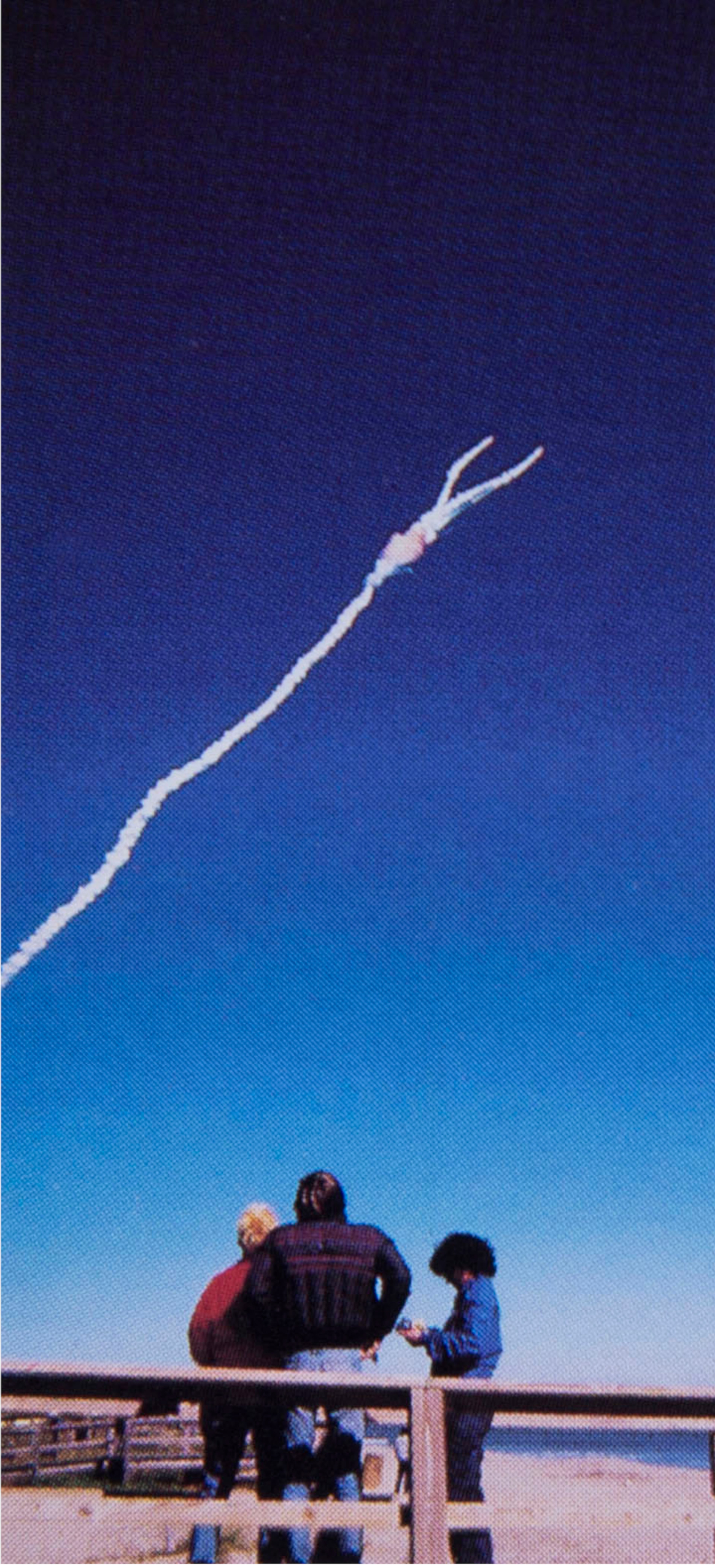 In the third of this series of Jan. 28, 1986 photos, the space shuttle Challenger explodes shortly after lifting off from the Kennedy Space Center in Cape Canaveral, Fla. A family from Michigan watches the explosion from Shepard Park in Cocoa Beach. (Malcolm Denemark/Florida Today via AP)