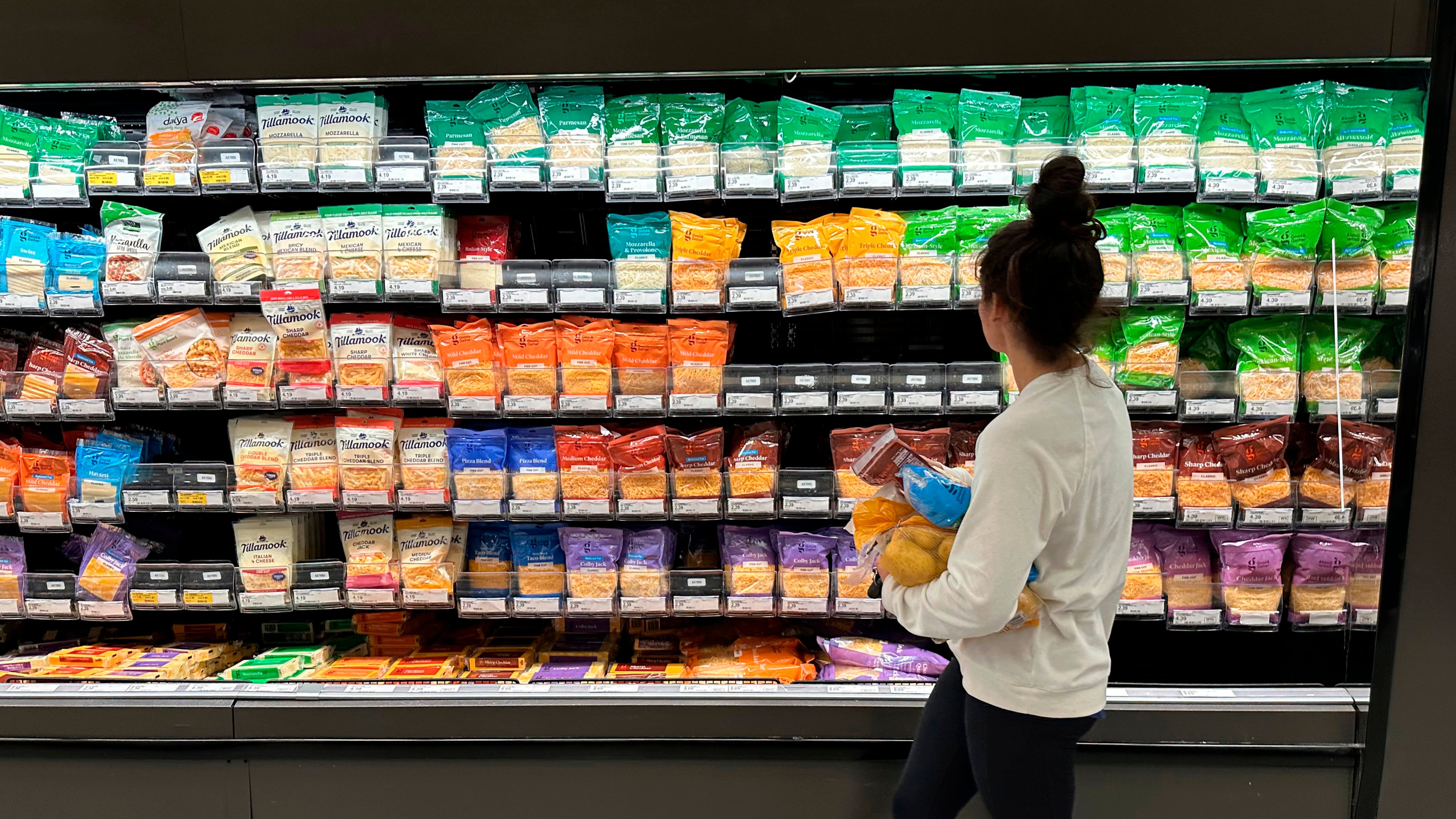 FILE - A shopper peruses cheese offerings at a Target store Wednesday, Oct. 4, 2023, in Sheridan, Colo. (AP Photo/David Zalubowski, File)