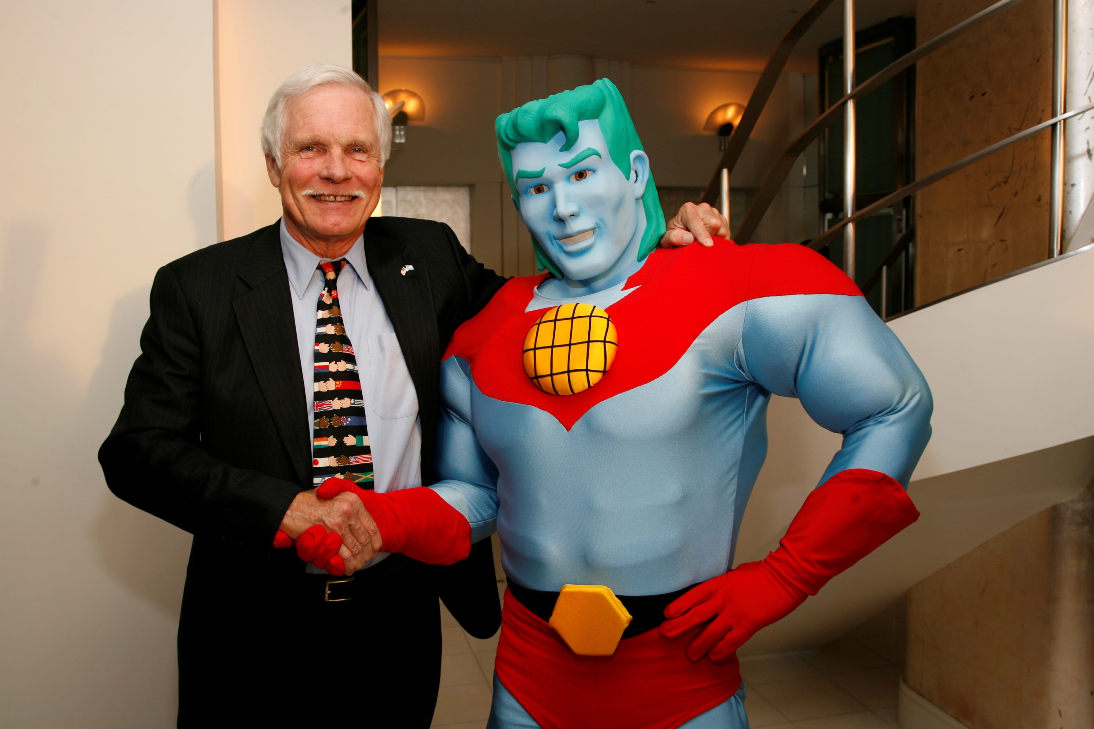 CNN Founder Ted Turner shakes hands with Captain Planet. (Courtesy)