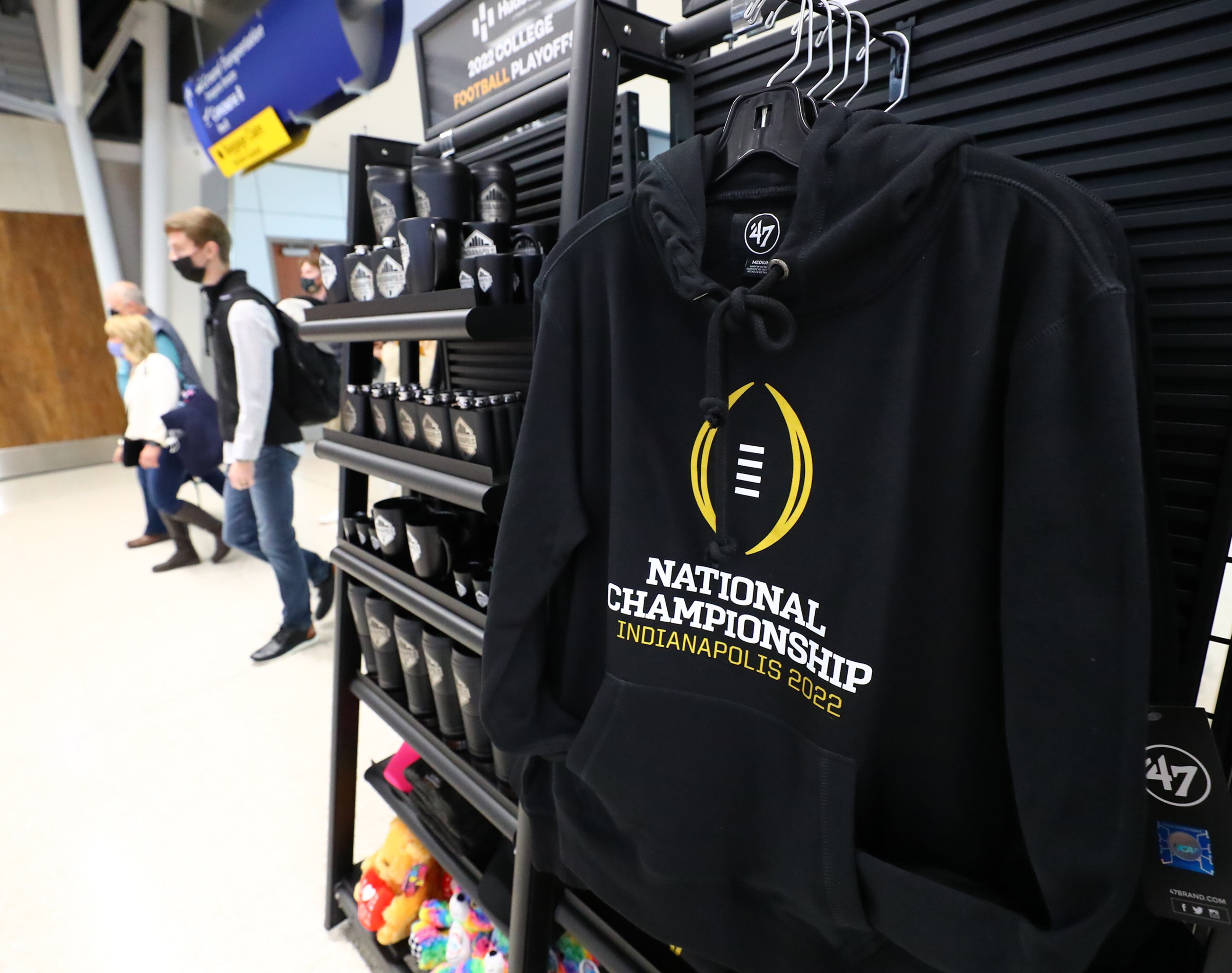 010622 Indianapolis: Travelors pass by National Championship souvenirs that are prevelant throughout the Indianopolis International Airport on Thursday, Jan. 6, 2022, in Indianapolis. “Curtis Compton / Curtis.Compton@ajc.com”`