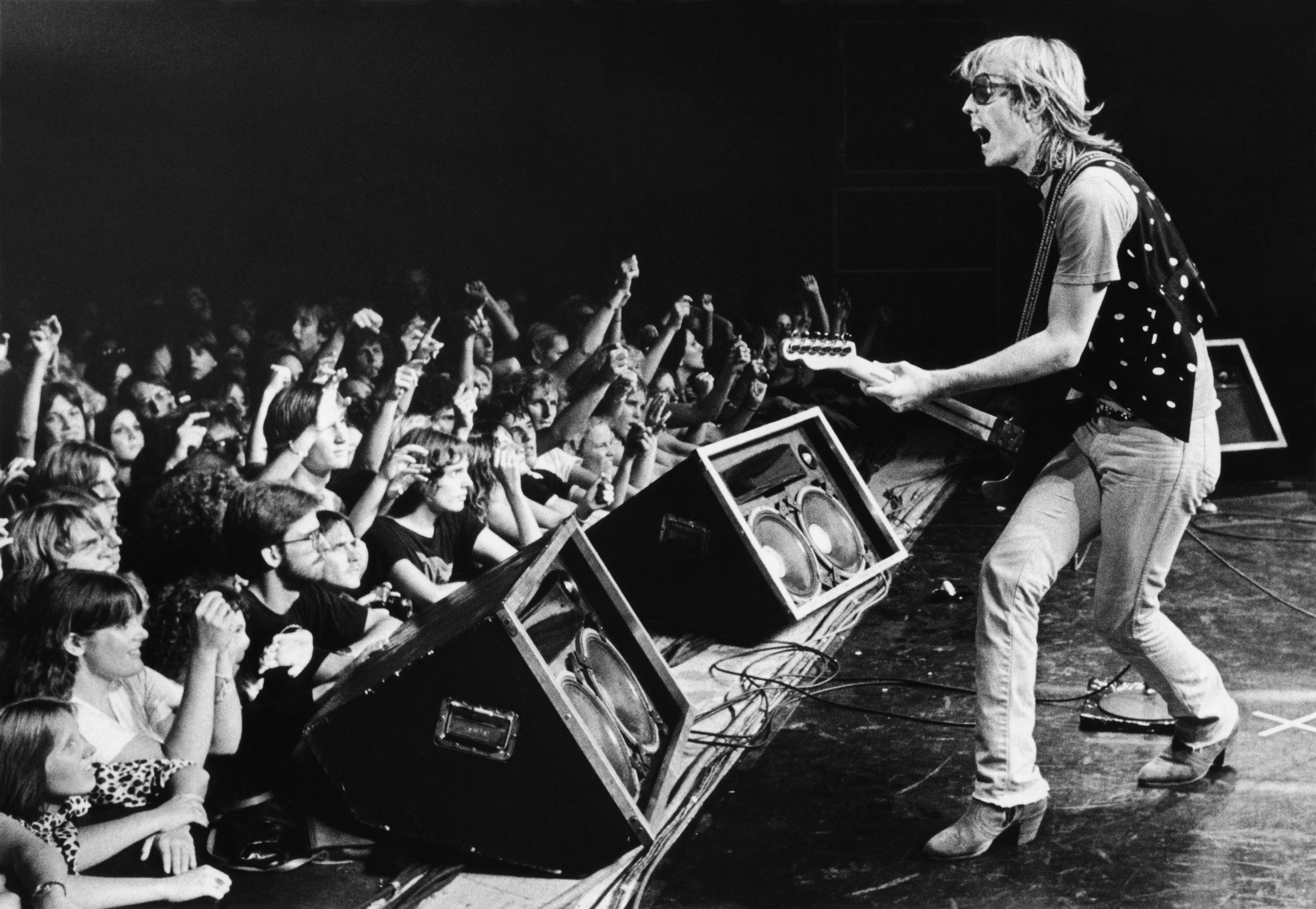 SANTA CRUZ, CA - 1980: Singer Tom Petty, backed by his band, The Heartbreakers, prances onstage during a 1980 Santa Cruz, California, concert at the Civic Auditorium. (Photo by George Rose/Getty Images)