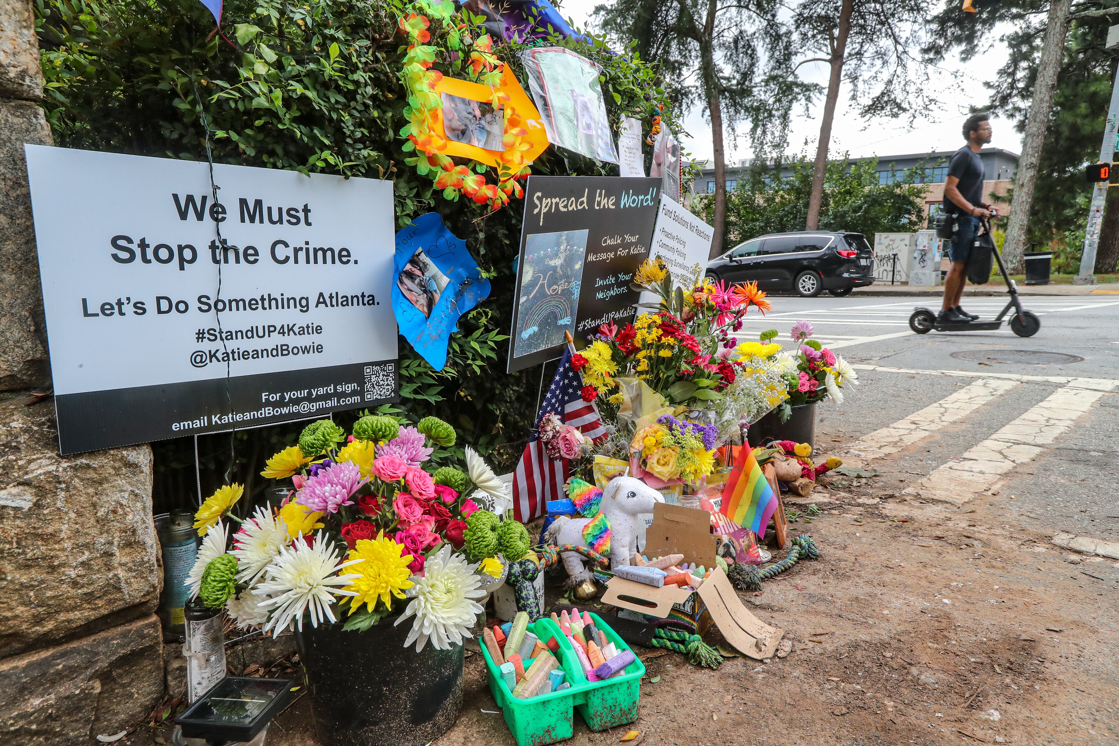 Mourners left flowers, posters and dog treats at a makeshift memorial outside Piedmont Park last summer following the high-profile killing of Katherine Janness and her dog, Bowie.
Spink / John.Spink@ajc.com)