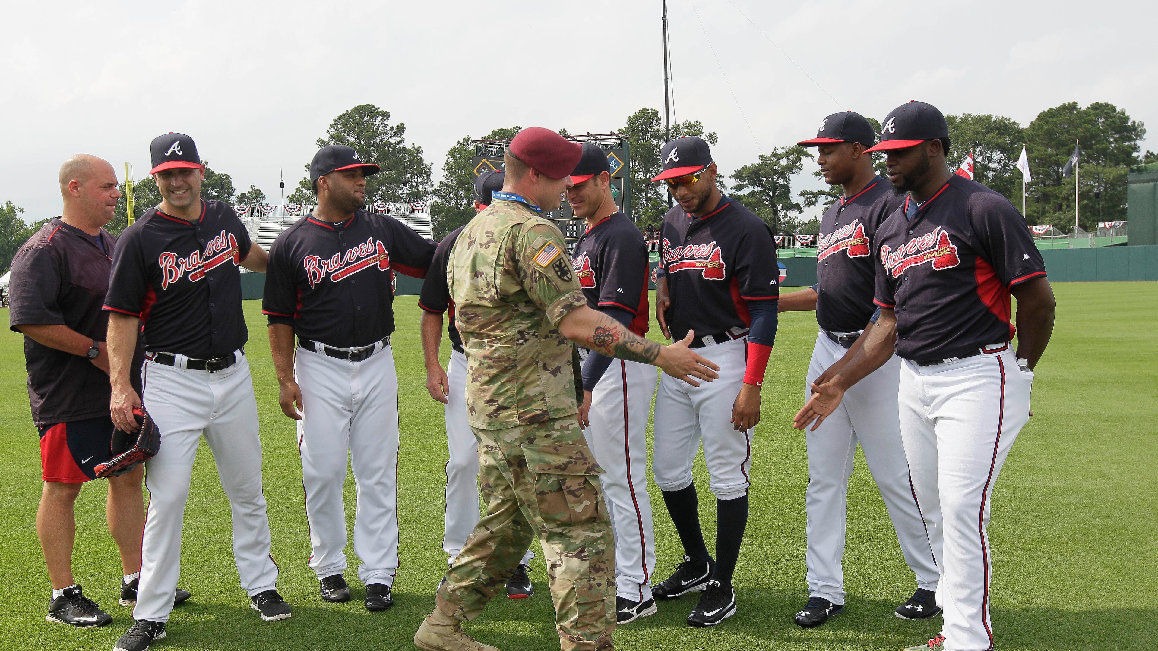 U.S. Army Sgt. Alex Burnett of the 82nd Airborne Division greets Atlanta Braves players prior to their game against Miami at Fort Bragg, N.C. (AP Photo/Gerry Broome)