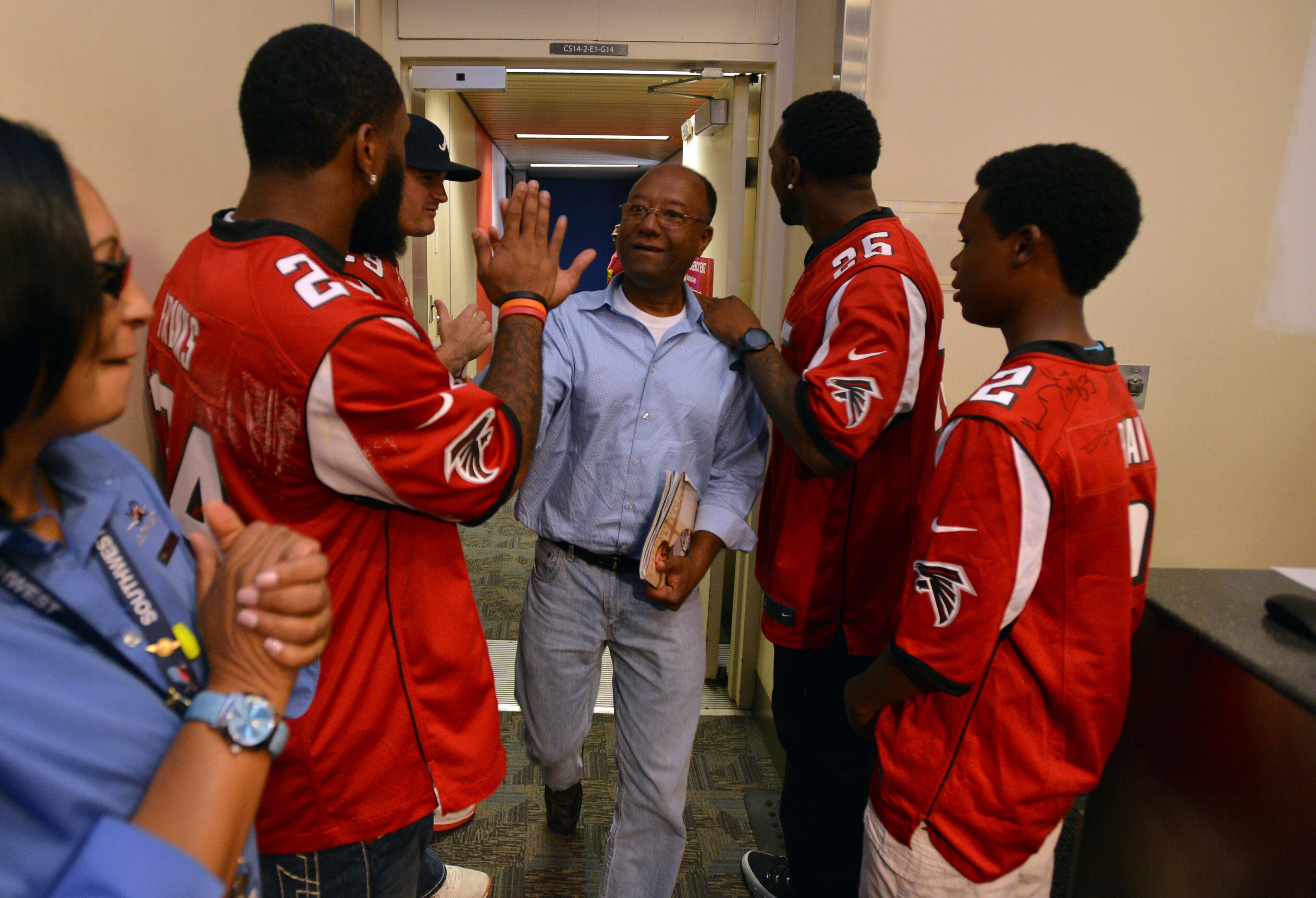 Members of the Atlanta Falcons surprised Southwest Airlines passengers by greeting them as they departed the plane. Five members of the Atlanta Falcons visited Southwest Airlines operations at Hartsfield-Jackson Atlanta International Airport with special guest Jordan Thomas. Thomas, 14, was diagnosed with cancer in 2012. As part of the Make-A-Wish Foundation, Thomas had the opportunity to hang out with members of the Falcons as they visited the Southwest ticket counter terminal, announced a flight departure and helped direct a plane away from the terminal. BRANT SANDERLIN /BSANDERLIN@AJC.COM