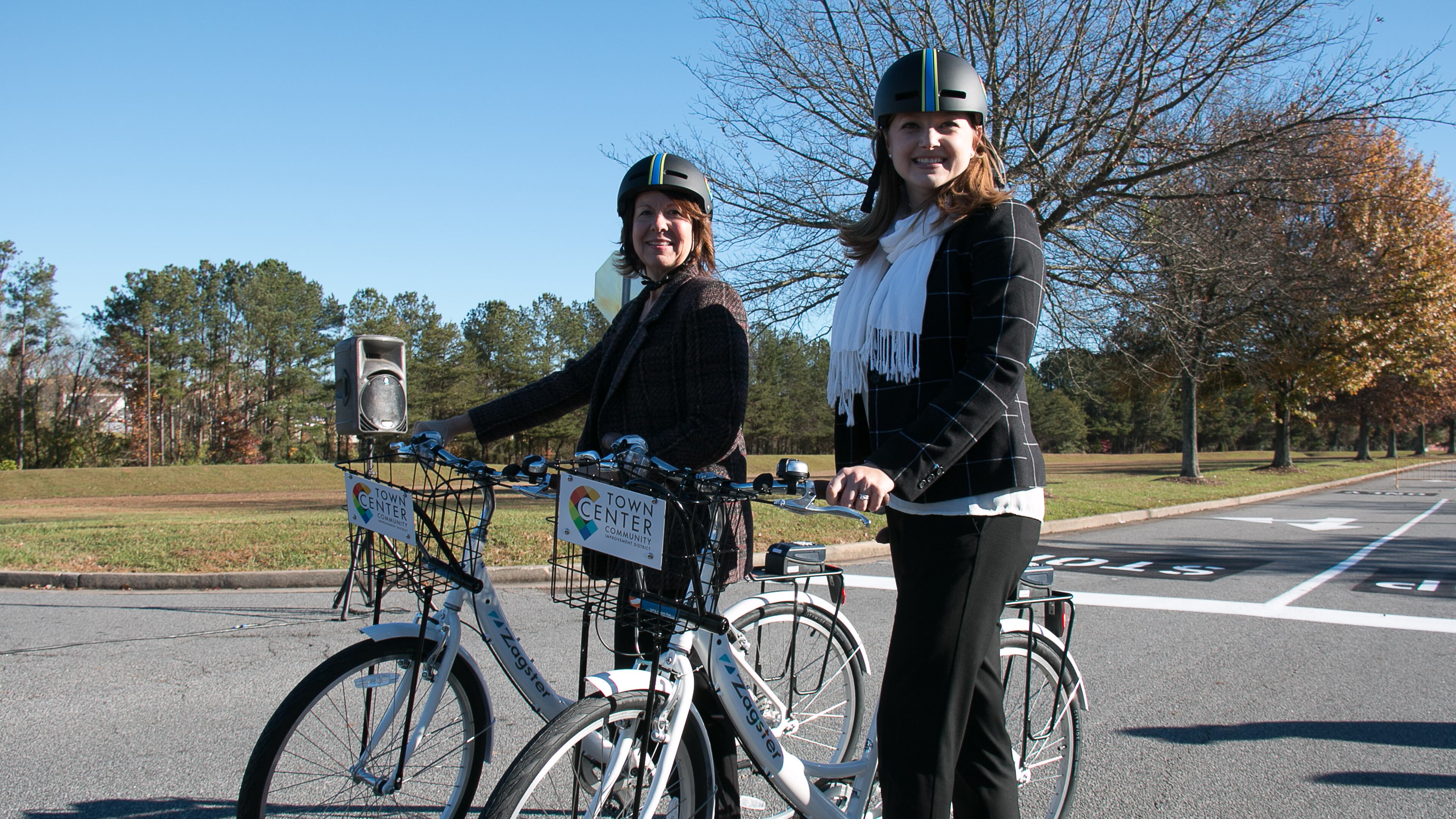 Faye DiMassimo, (left) the director of the Cobb County Department of Transportation, and Tracy Rathbone, (right) executive director of Town Center Community Improvement District pose with new Zagster bike share bicycles on Friday, Nov. 20, 2015. Photo courtesy of Town Center CID.