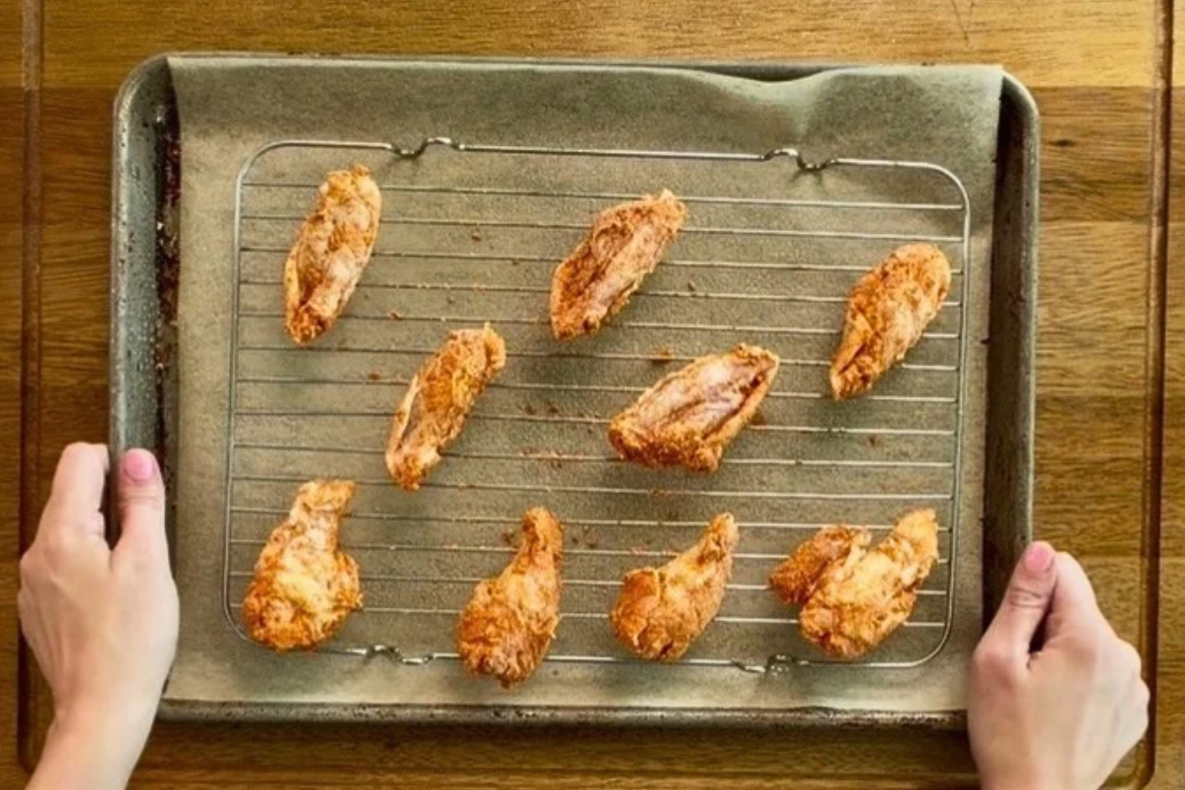 Space the wings on a greased wire rack so hot air can circulate underneath as they bake.
