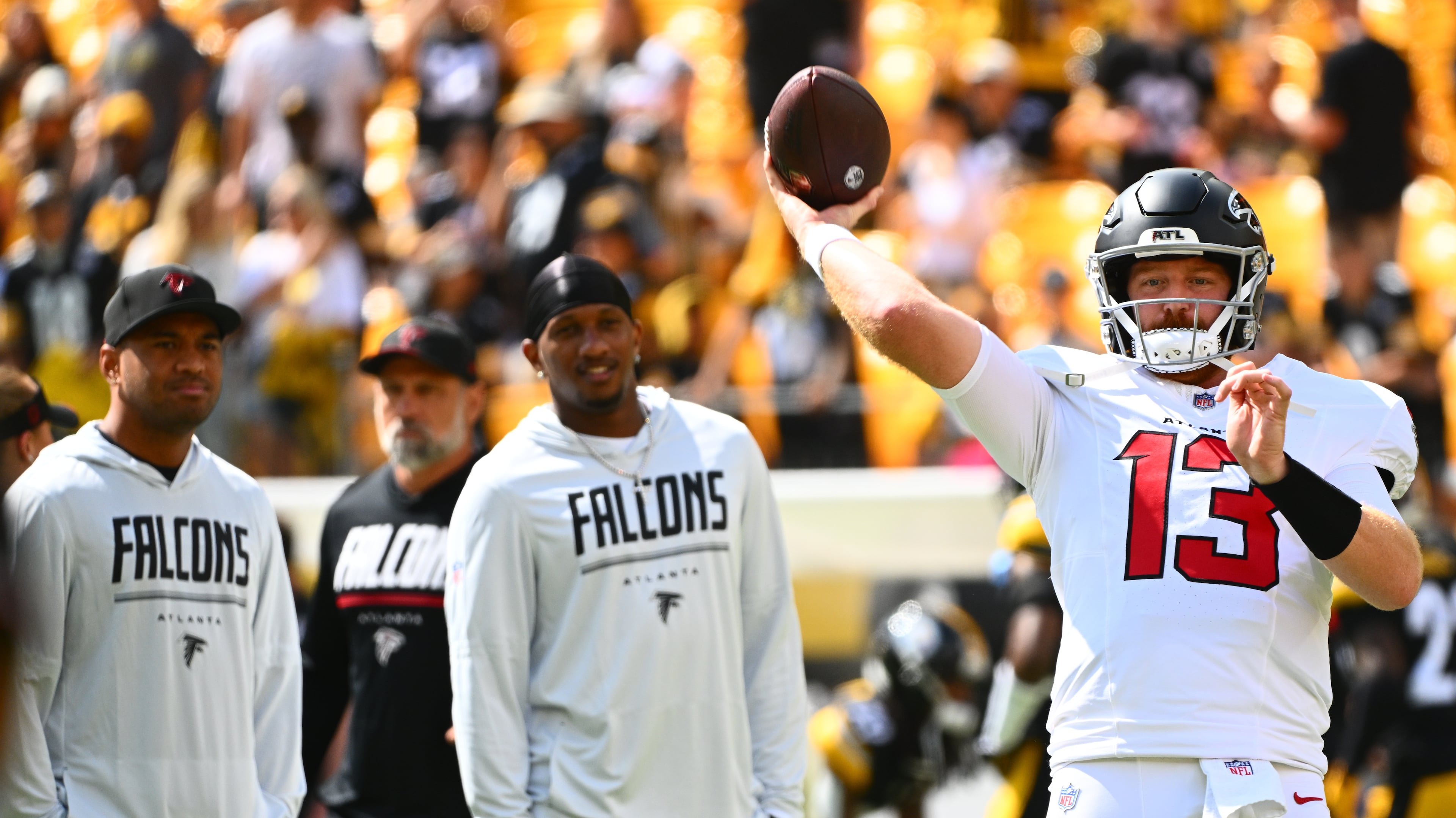 Atlanta Falcons quarterback Cooper Rush (13) warms up with Atlanta Falcons quarterback Tua Tagovailoa (1) and Atlanta Falcons quarterback Michael Penix Jr. (9) behind him before an NFL football game, Sunday, Sept. 13, 2026, in Pittsburgh. (AP Photo/Justin Berl)