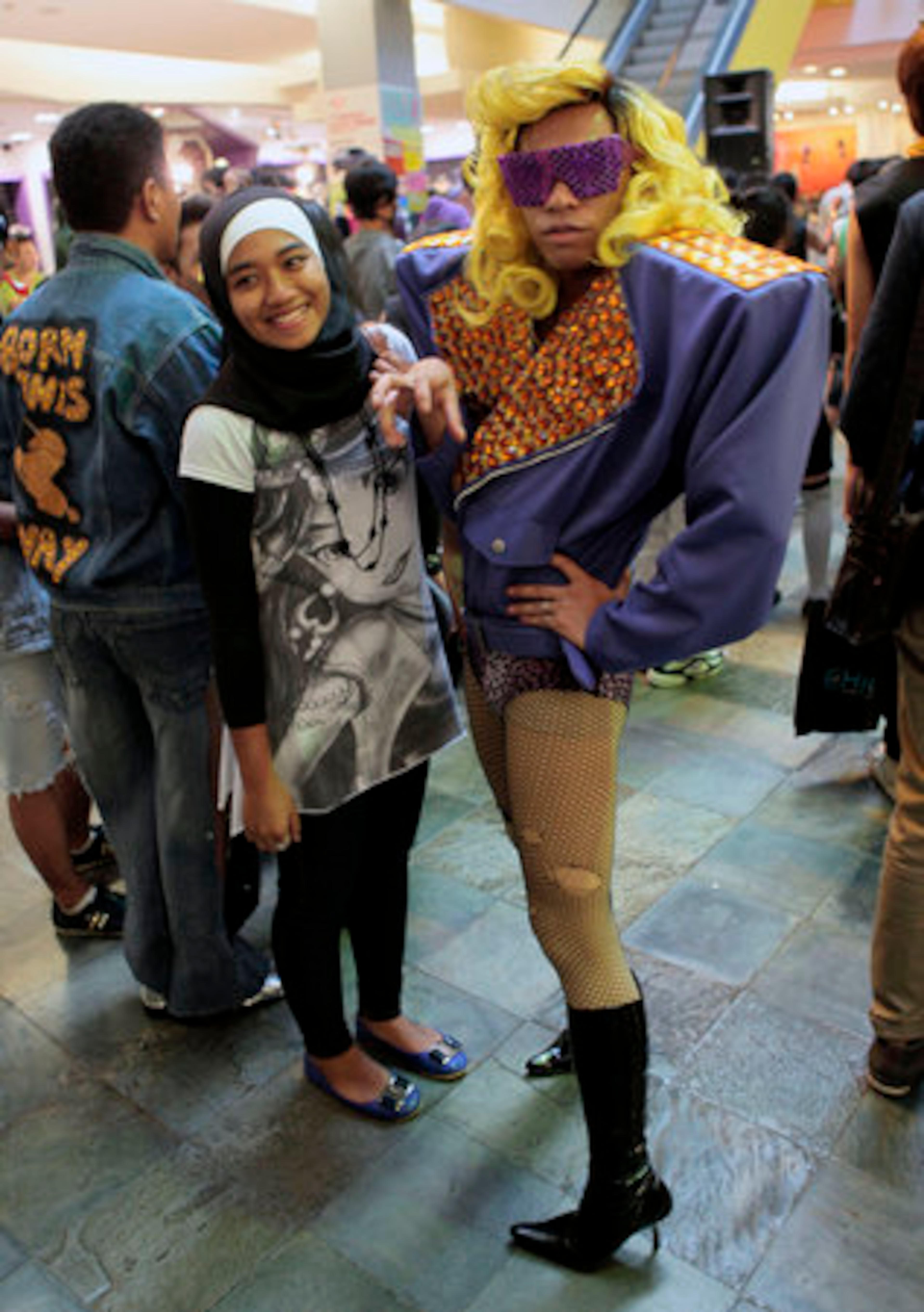 A Muslim girl poses for a photo with a fan of U.S. pop star Lady Gaga as the fans gathered for a flash mob at a shopping mall in Jakarta.