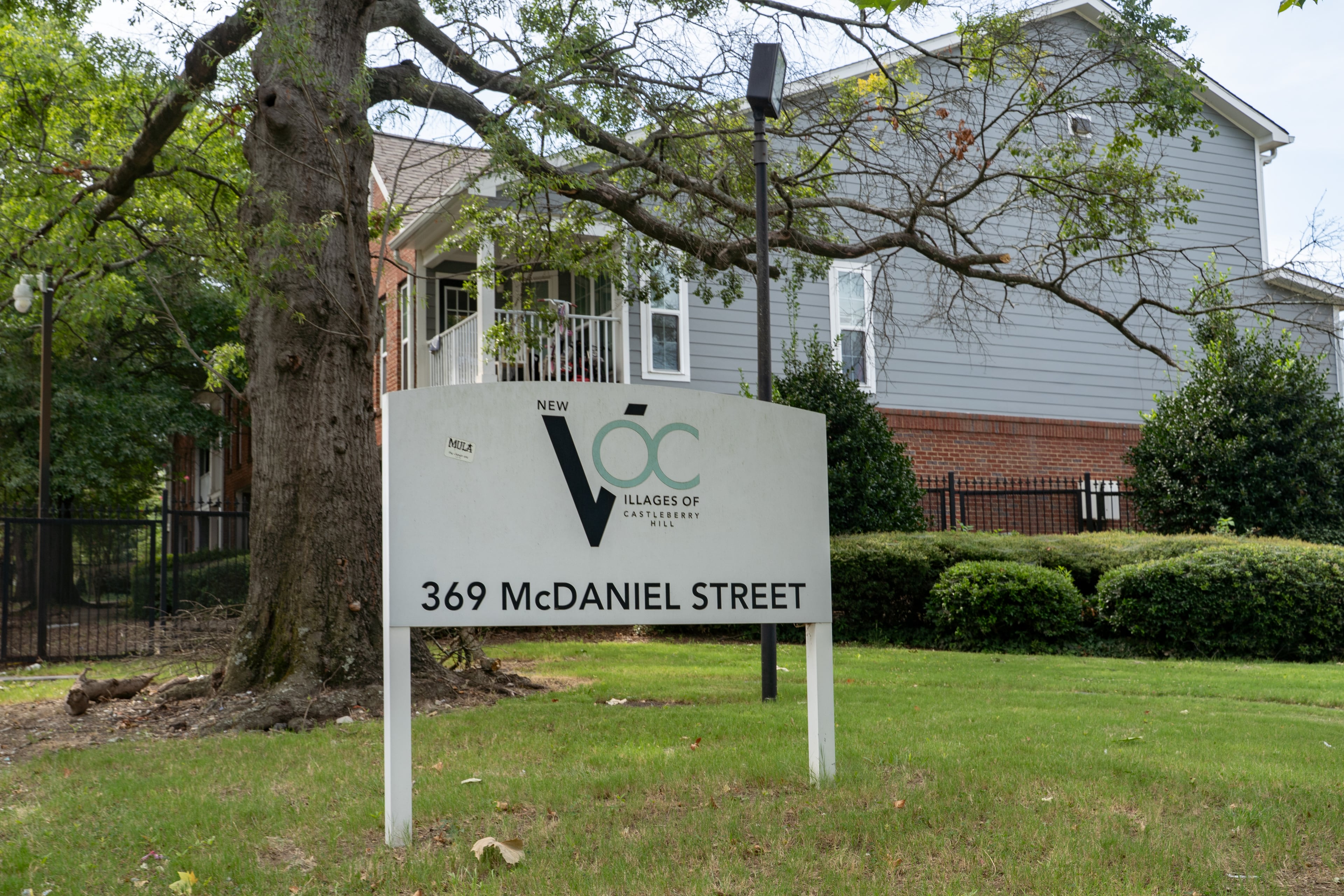 A sign identifies the complex as the Villages of Castleberry Hill where a shooting took place early Friday, Aug. 21, 2026. (Ben Hendren for the AJC)