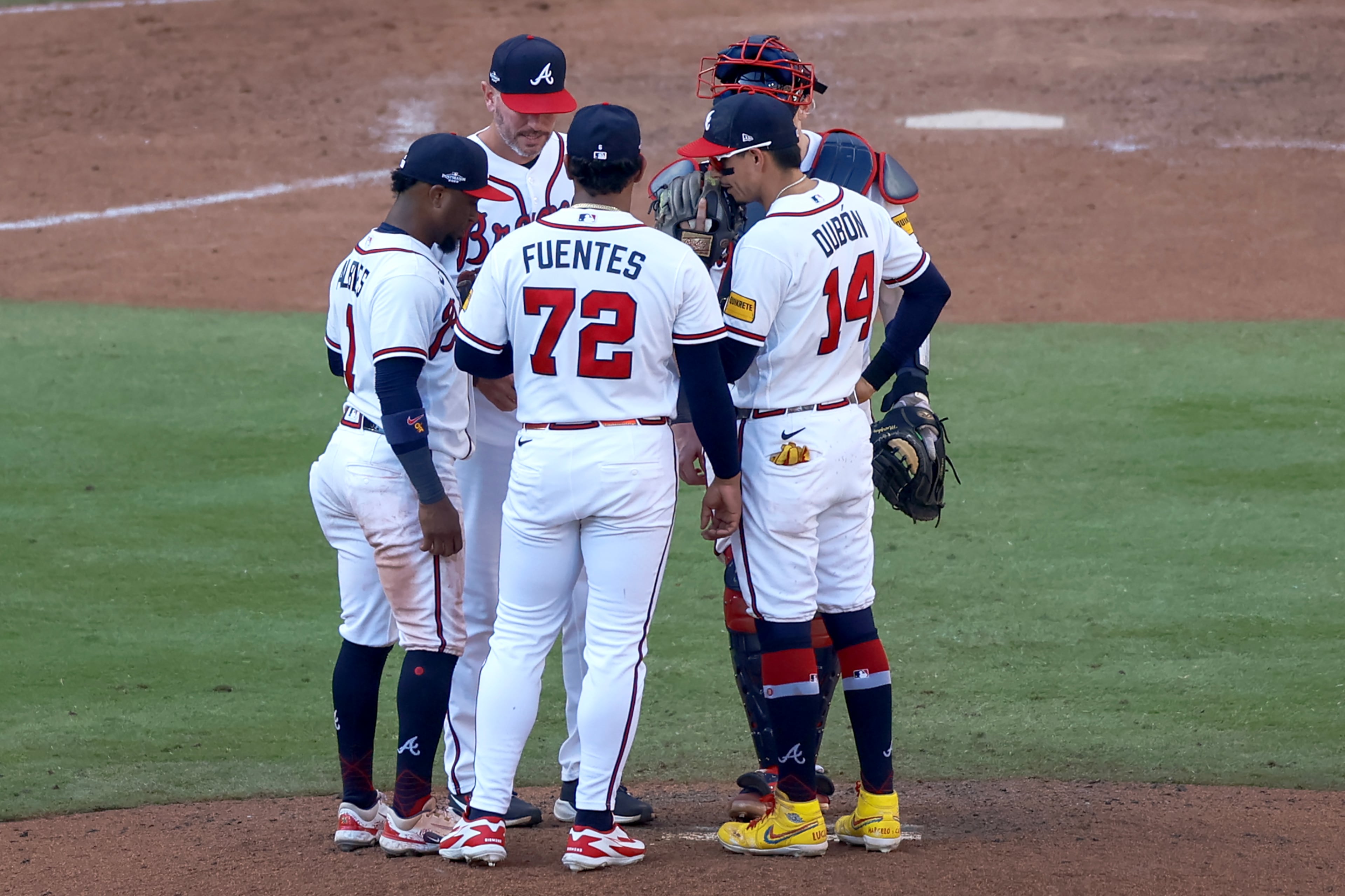 Braves pitcher Didier Fuentes (center) meets with pitching coach Jeremy Hefner and infielders during Game 2 of their NL Wild Card Series against the Phillies on Wednesday, Sept. 30, 2026, in Atlanta. (Miguel Martinez/AJC)