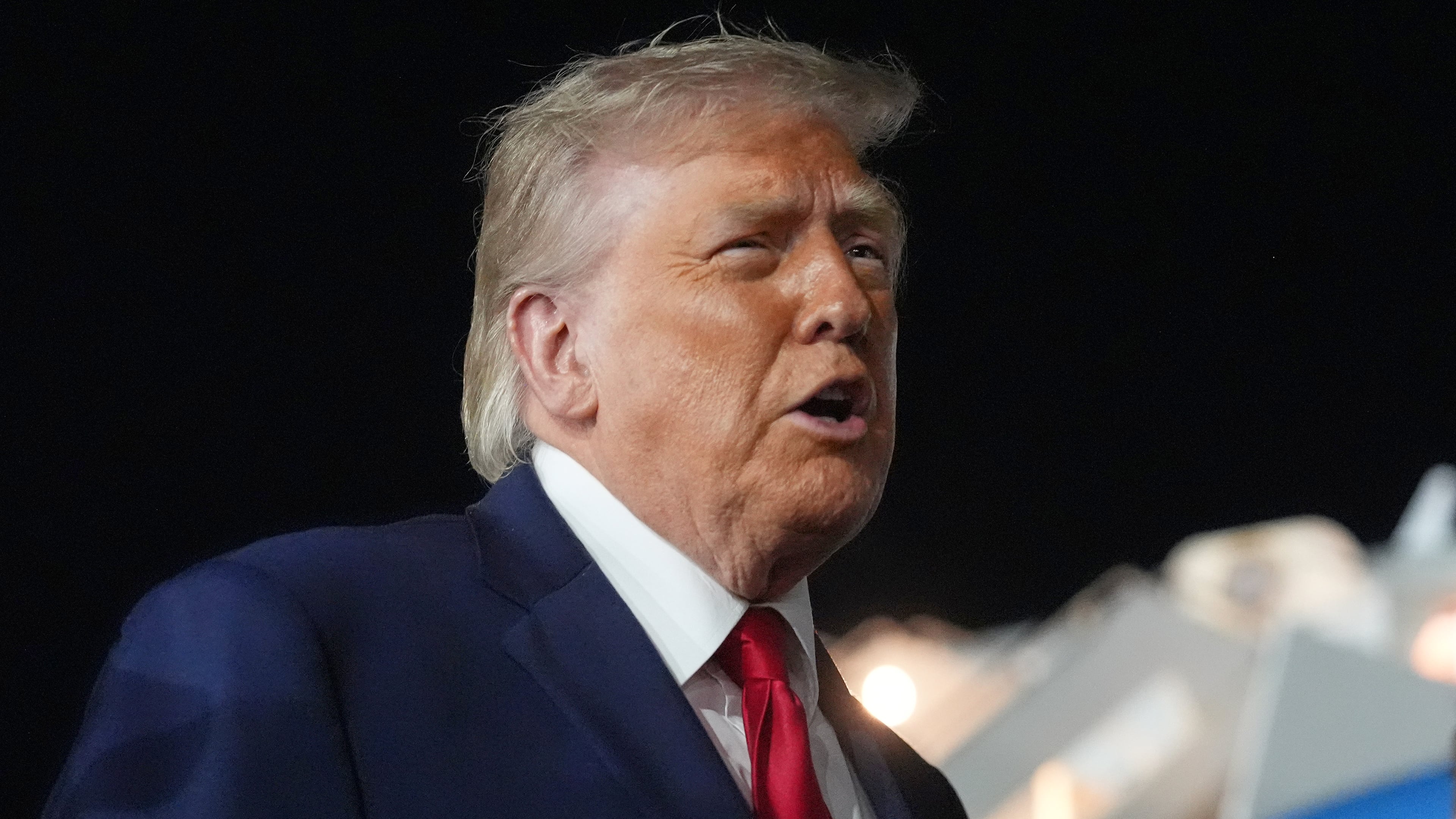 President Donald Trump talks with reporters before boarding Air Force One at John F. Kennedy International Airport in New York, early Tuesday, June 9, 2026. (AP Photo/Mark Schiefelbein)